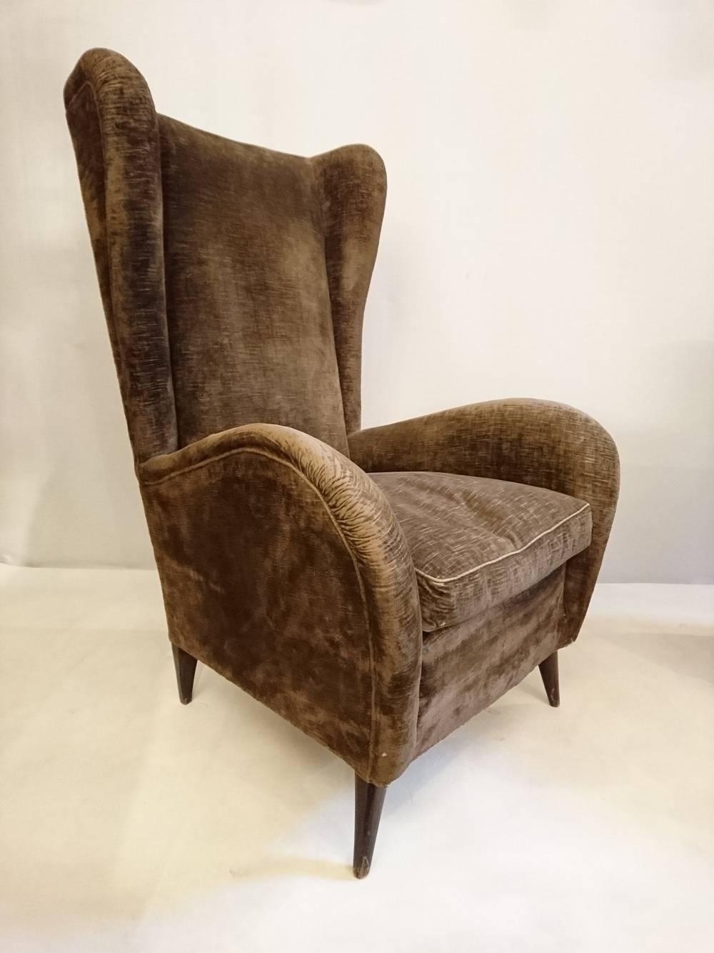 Wingback armchairs in the original fabric in the manner of Gio Ponti. These chairs will need reupholstery work. 