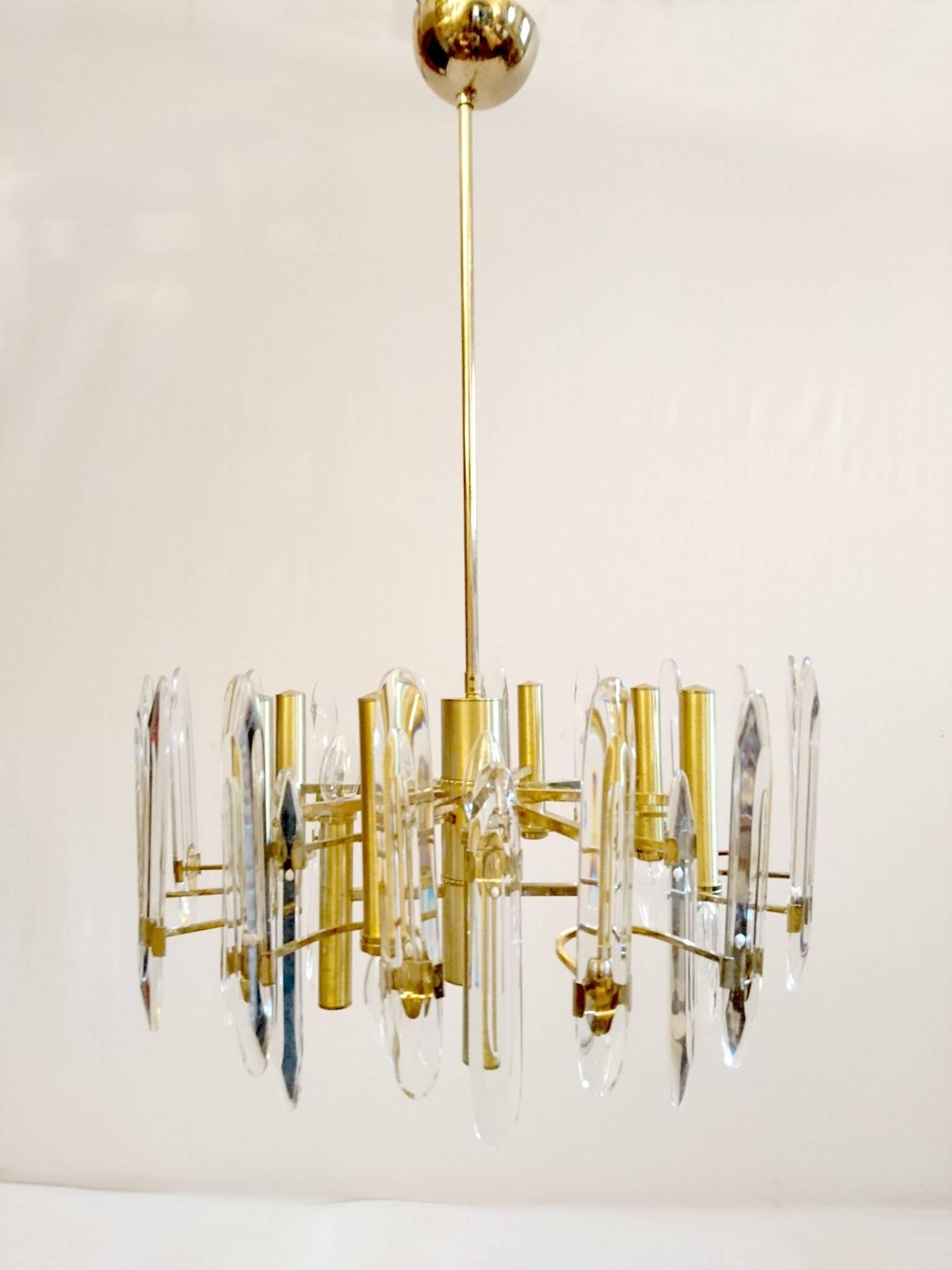 Chandelier in Classic Sciolari design in brass and crystal glass. Has 12 lights and comes with two extra spare crystal pieces. For a small sum the height can be adjusted to required height if needed.