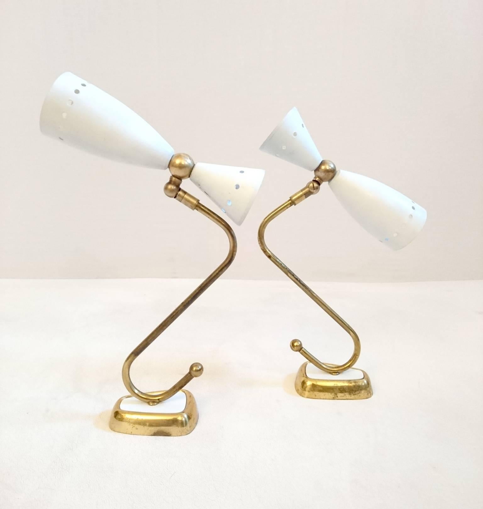 Classic pair of 1950s wall lights by Stilnovo. The light cone is adjustable in all angles. The coating is original and in good condition but with small signs of age which only proves it´s originality.