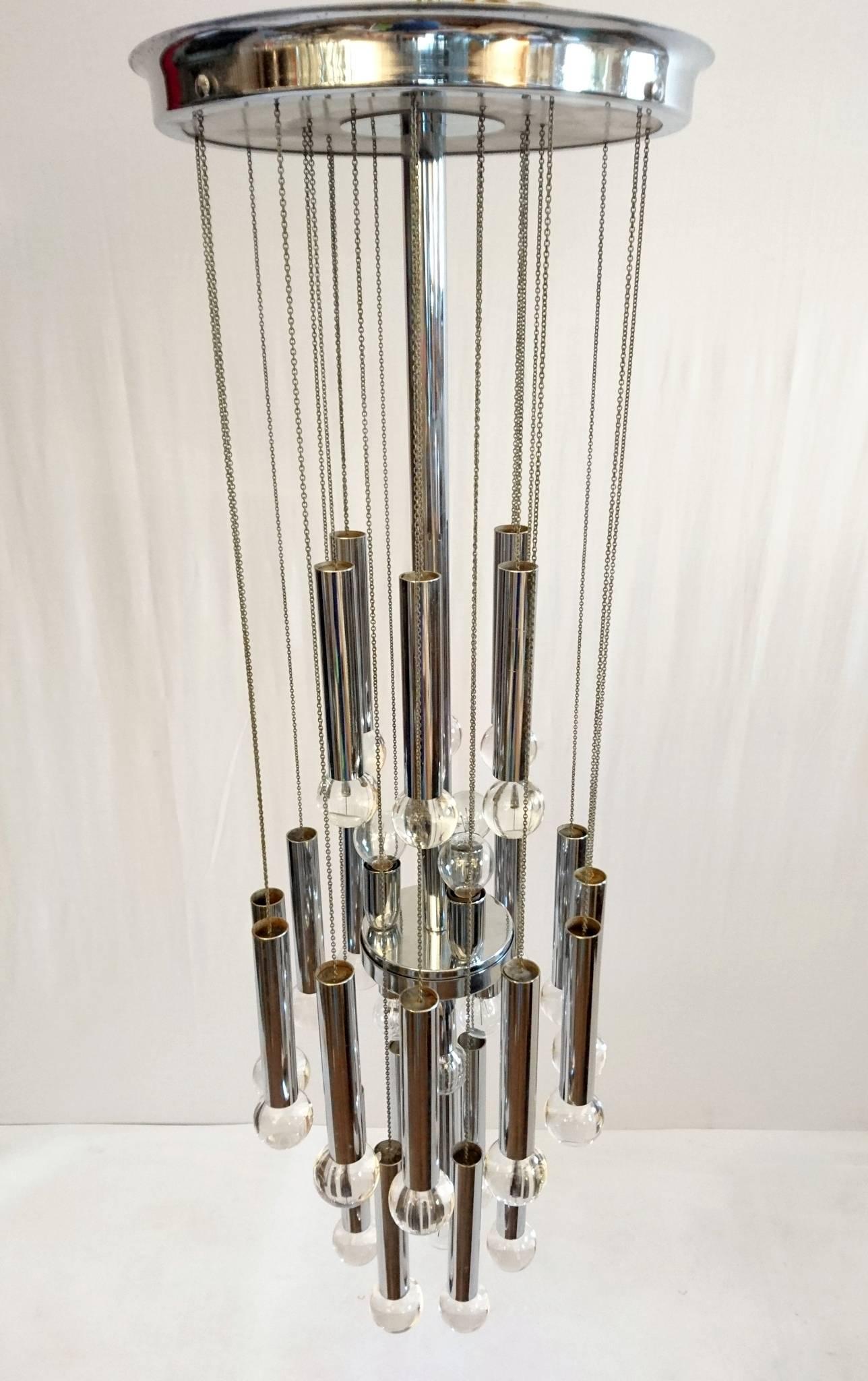 Slender chandelier by Gaetano Sciolari with 24 solid glass balls hanging in chains. All in chrome and made for seven light bulbs.