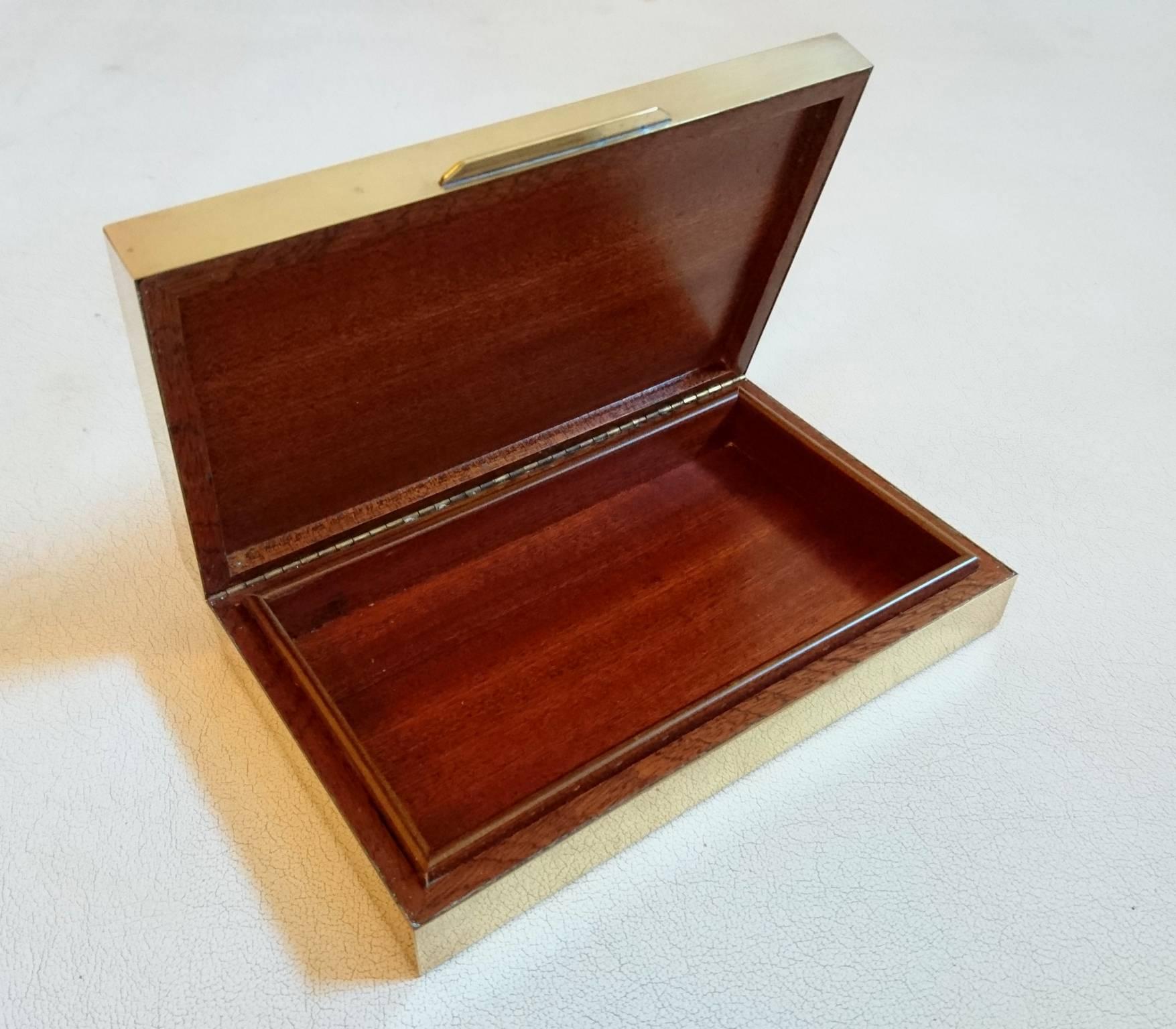 Box for trinkets or jewelry made in brass with a glass top covering a layer of rattan with an inside and bottom made in mahogany. The box is of a high quality finish and closes perfectly.