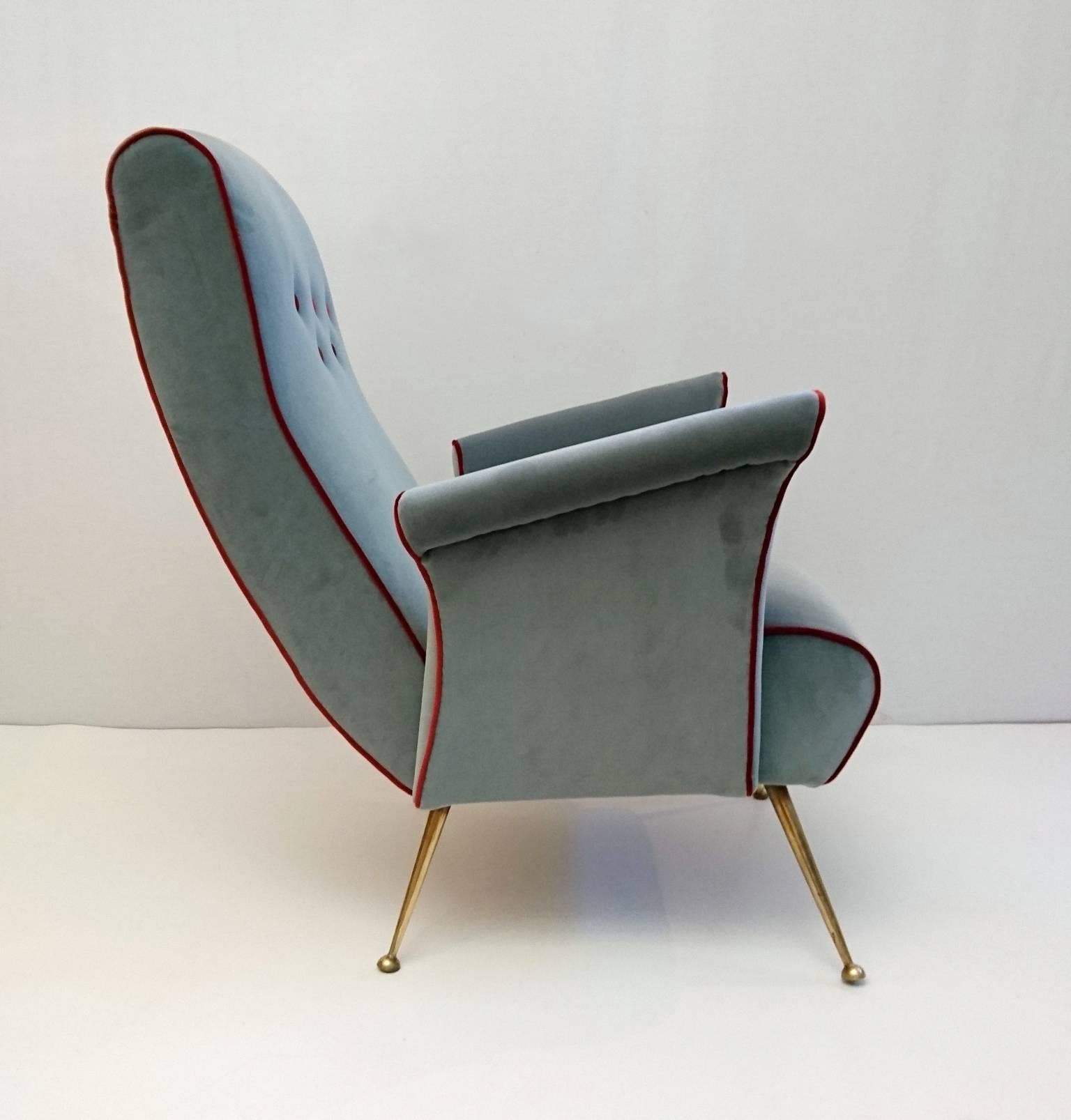 This armchair with brass spider legs has recently been completely professionally reupholstered in a soft gray velvet with crimson red piping and buttons. Comfortable as well as elegant.