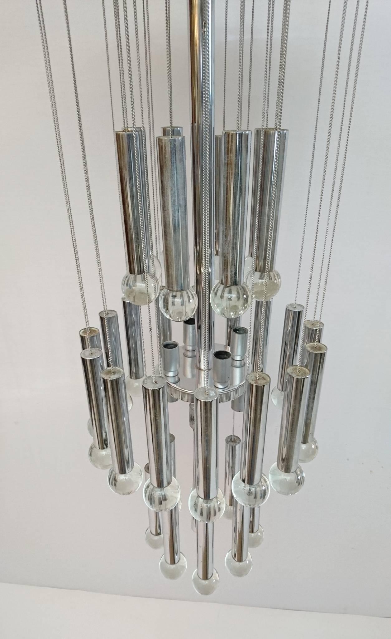 Slender chandelier by Gaetano Sciolari with 32 solid glass balls hanging in chains. All in chrome and made for nine-light bulbs.