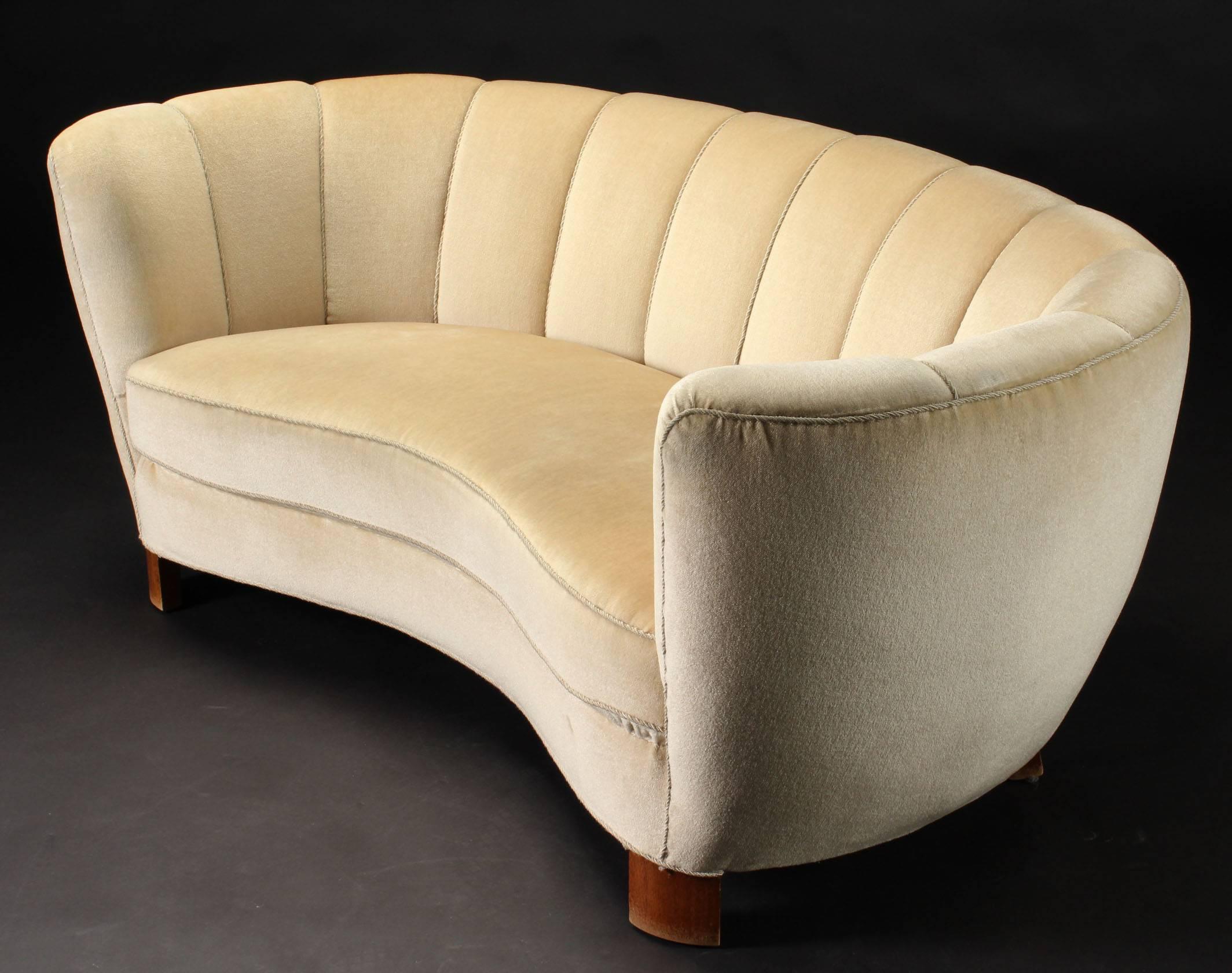 Beautiful three-seat sofa produced in Denmark in the 1940s. It is in it´s original condition with ivory mohair fabric. The legs are made of beechwood. This sofa is perfect to put in the middle of a room away from the wall. Wear to the armrests