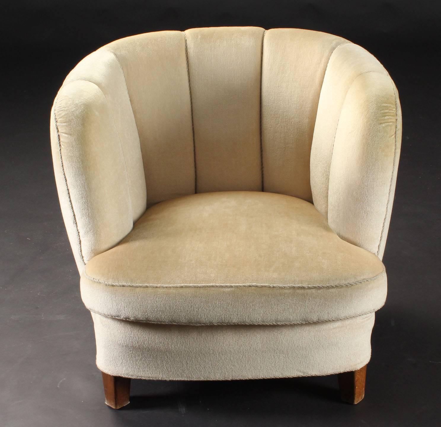 A low but comfortable armchair produced in Denmark in the 1940s. It is in it´s original condition with ivory mohair fabric. The legs are made of beech wood. See also the matching sofa and wingback in similar form and fabric.