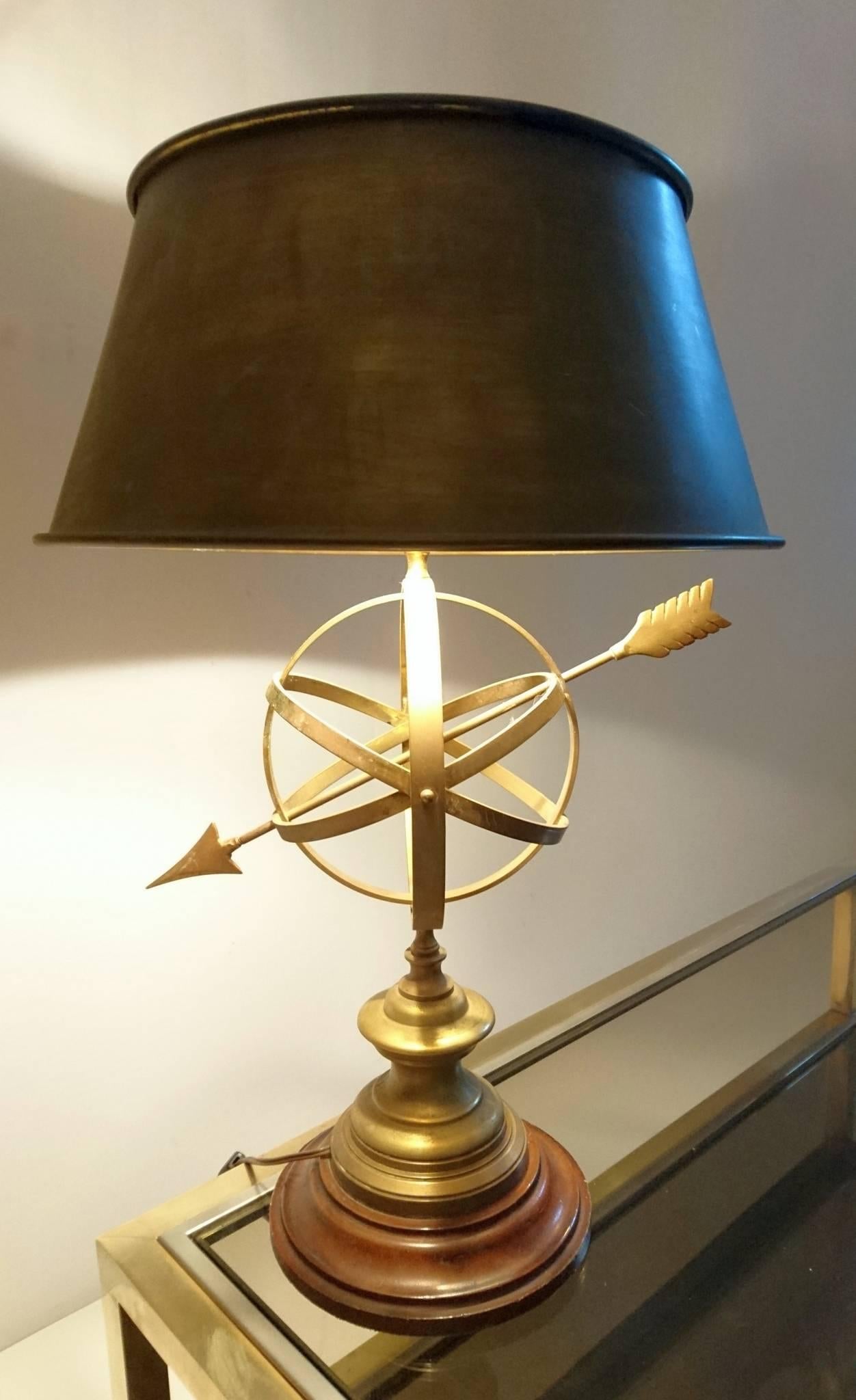 Vintage table lamp with a stained wooden base and centre in solid brass with a sundial. The shade which is original is also made of patinated brass. Has room for two standard E27 bulbs. Gives a warm glow when lit.