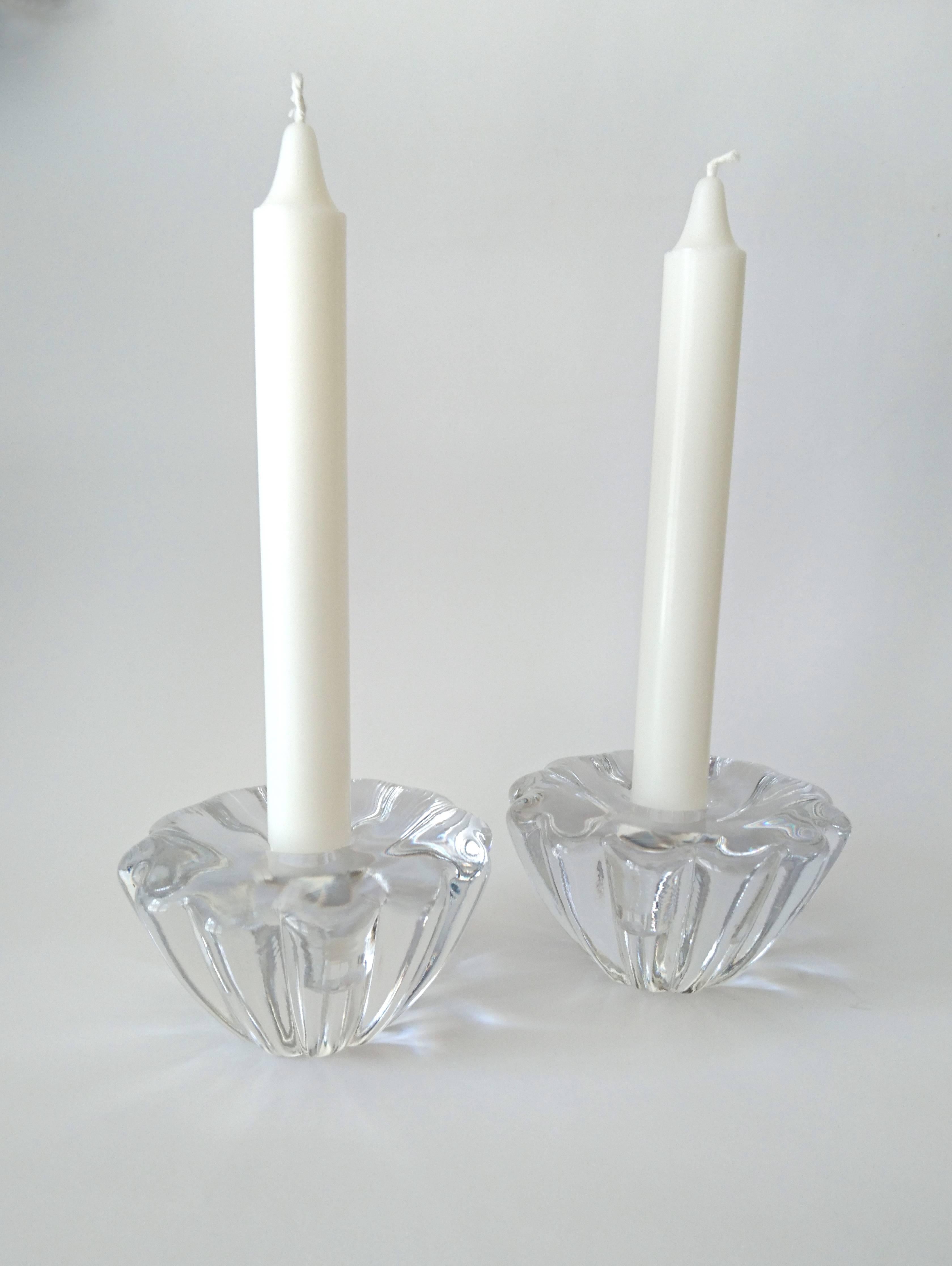 A pair of candleholders shaped like flowers by Sven Palmqvist for Orrefors. Signed in the bottom. See other listing for a similar pair but slightly smaller.