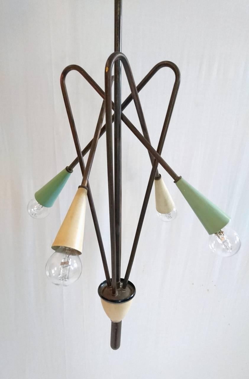 Pendant in blackened brass and painted metal with room for four-light bulbs.