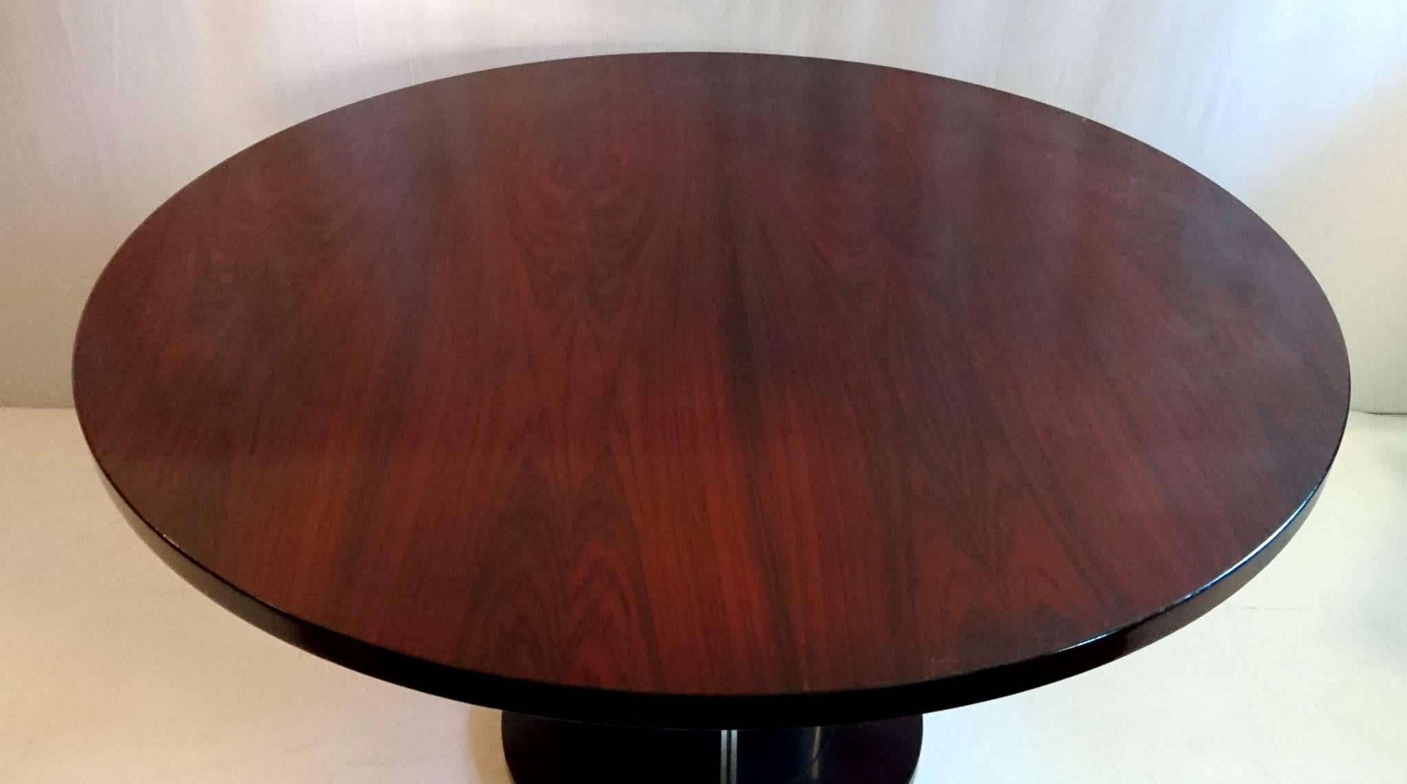 Dining table, model with a top made from rosewood and a pillar made from purple-colored plexiglass and aluminium with a rosewood base. Simply astonishing quality and the top looks like new.
This table has been part of a dining room set. Please look