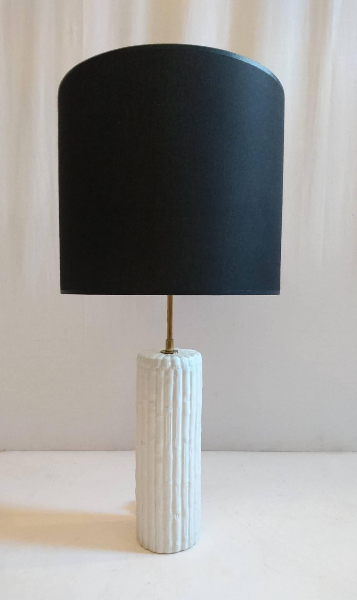 Graceful table lamp in white porcelain made to look like bamboo with a brass stem to hold the brand new black lampshade.