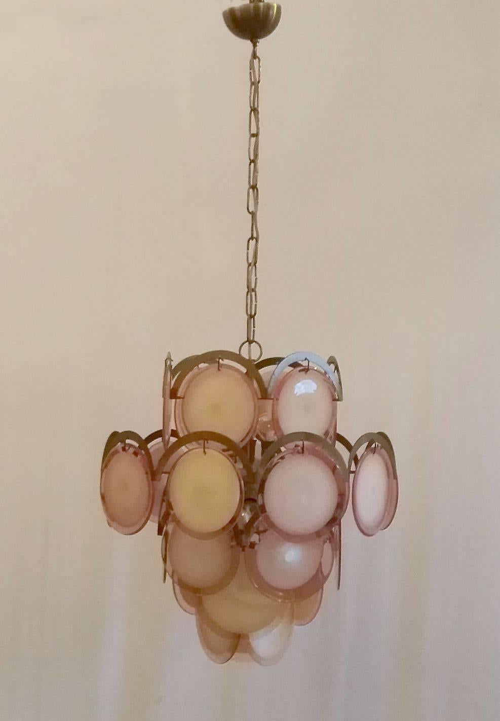 Classic chandelier by Gino Vistosi with rose colored handmade glass discs set on a brass frame.