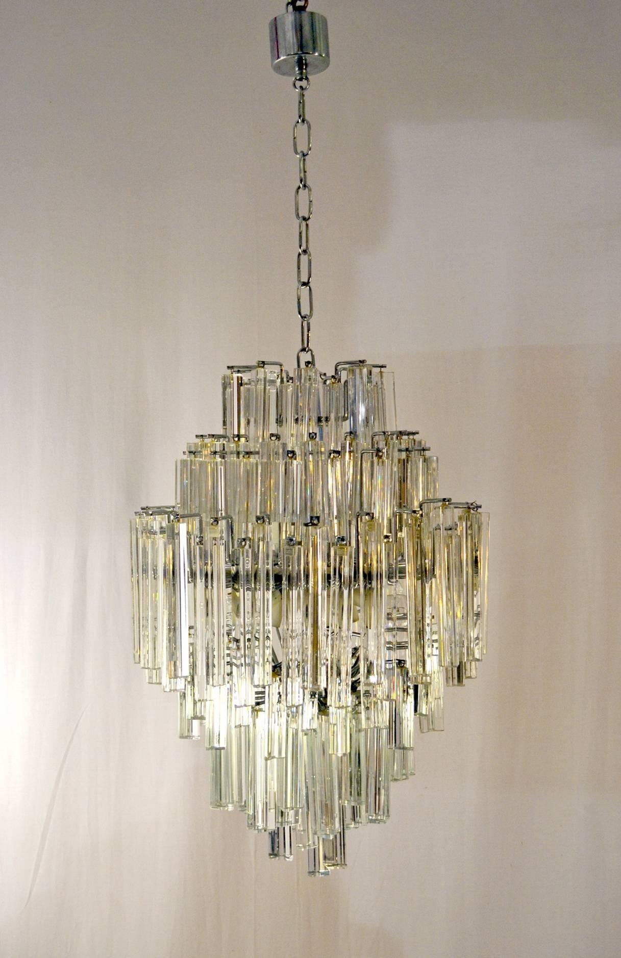 A 170 piece crystal so-called Triedri chandelier manufactured by Venini, Murano. The crystals are in different sizes and are hanging in tiers on a steel chromed base. Gives magnificent light and reflections in the room. The structure is 70 cm high