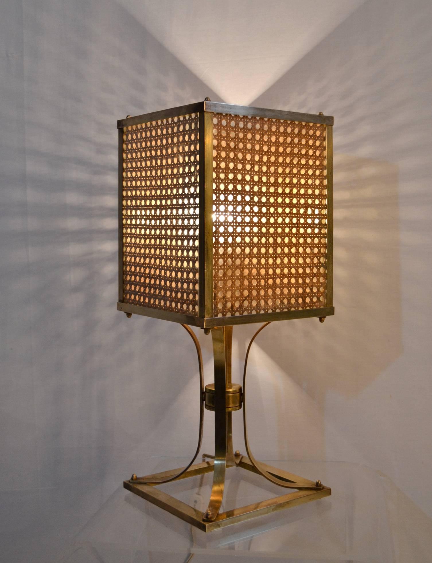 Rare table lamp in brass and rattan in the manner of Gabriella Crespi. The rattan is pressed beteween two folds of glass on each side and framed by brass. When lit it gives a very nice reflection and warmt.