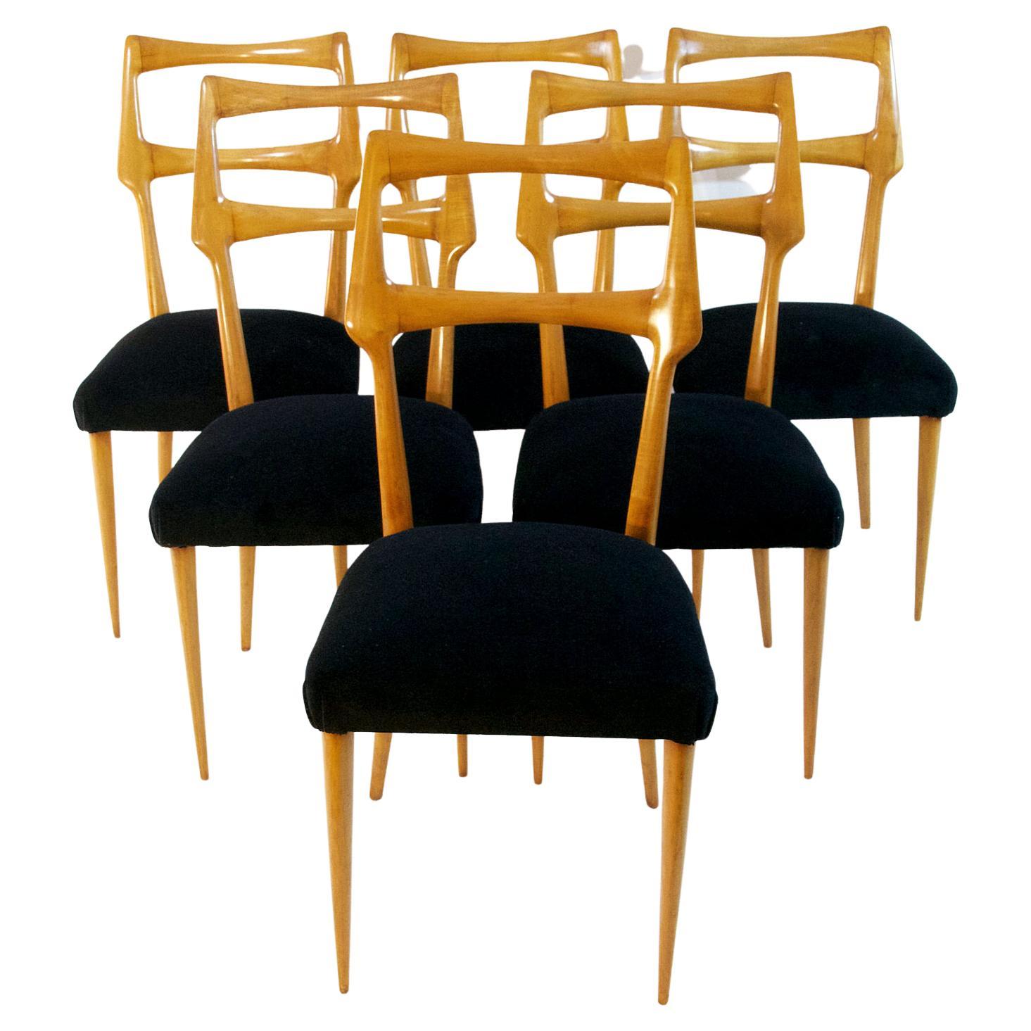 A set of six Italian dining chairs with a sublime organic design in maple attributed to Augusto Romano and re-upholstered in black velvet. The chairs have supreme craftsmanship and are in great condition. Very comfortable for long dinner parties.
  