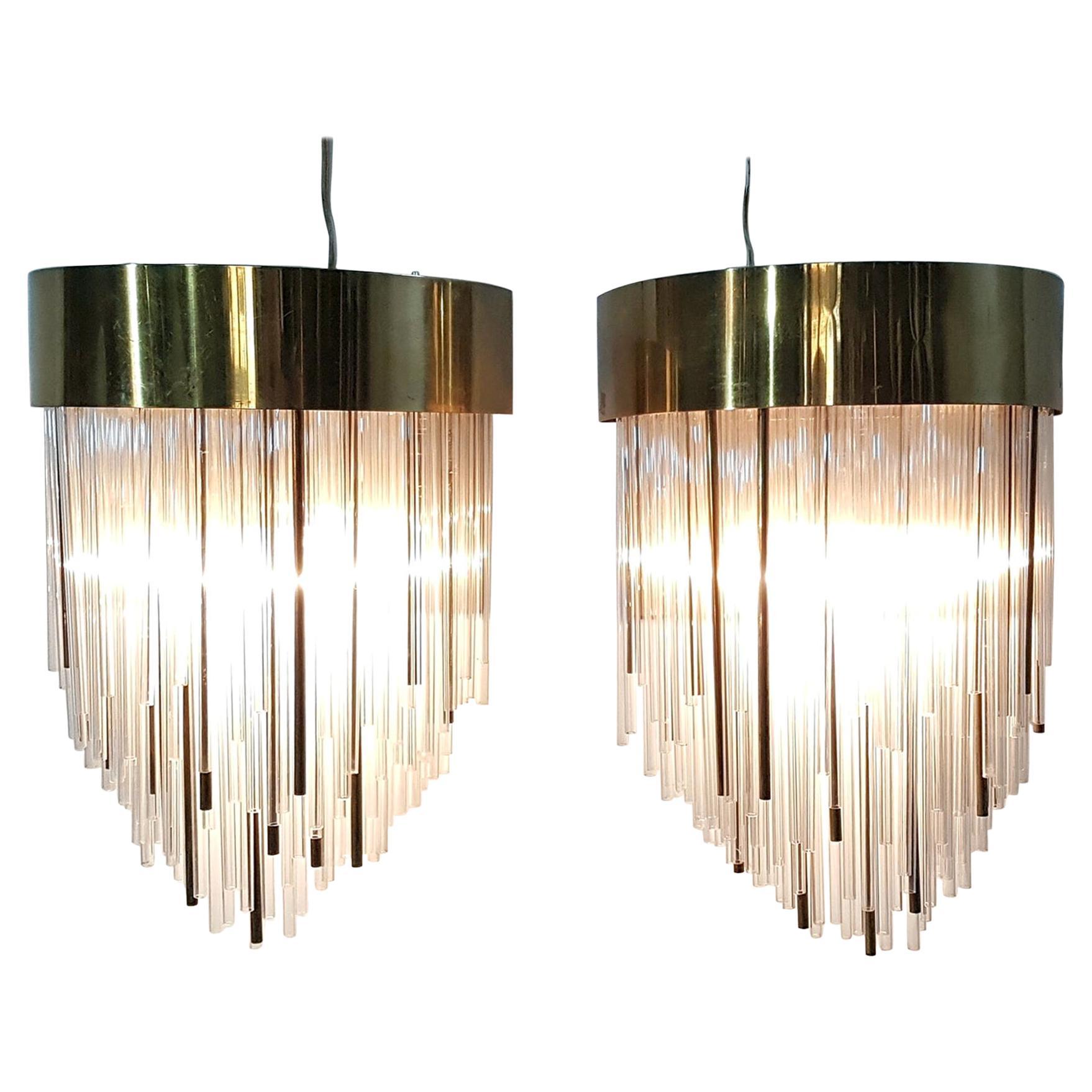 A pair of unusual and beautiful wall sconces in art deco style produced during the 1970's with glass and brass 
