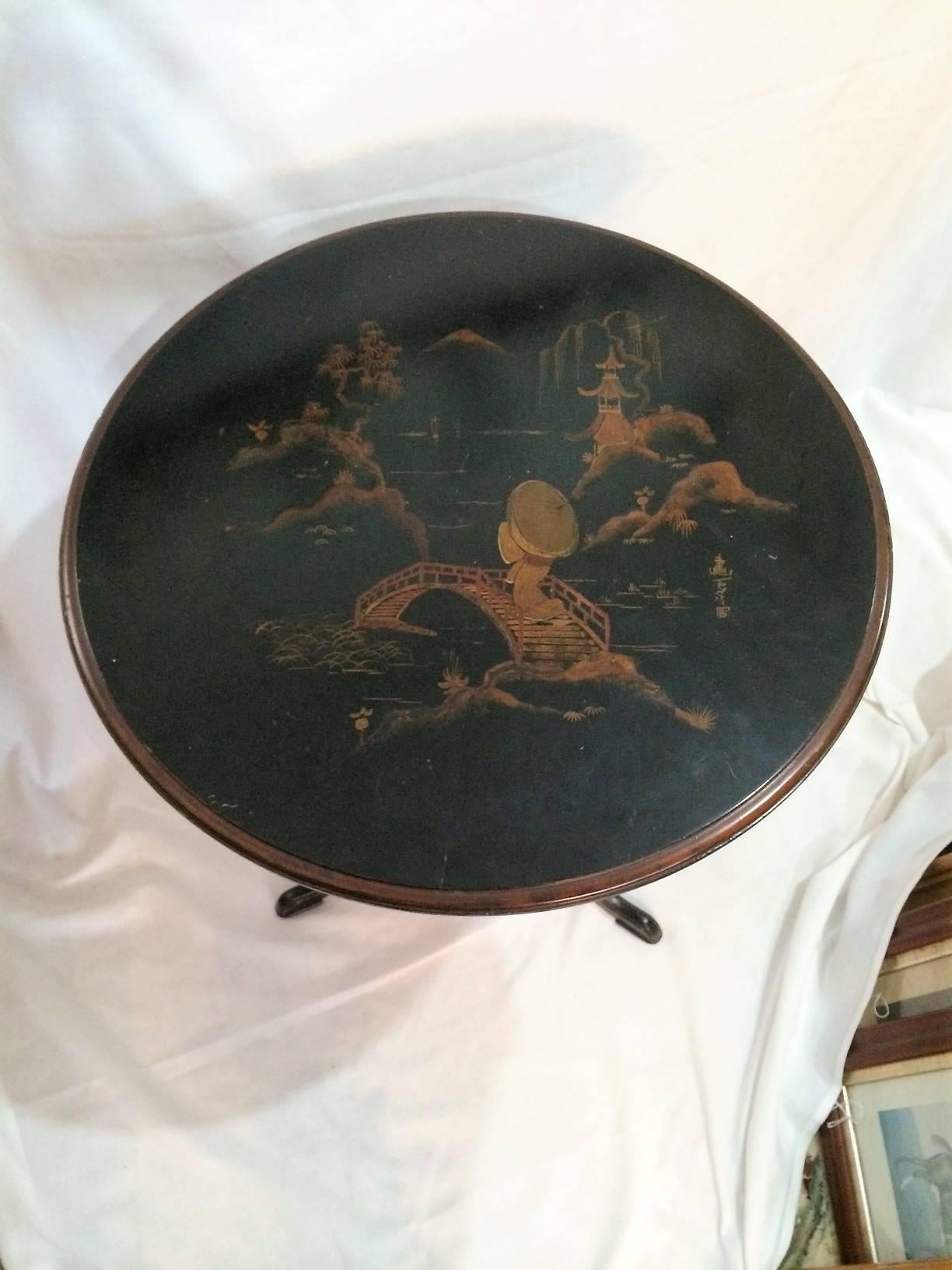 Beautiful Hand-Painted Round Black & Gold chinoiserie Table On Tripod Base. Simple Elegance.

This needs some love. The structure is sturdy...the top in antique condition. Some minor wear - not in structure...structure perfect.. Selling 
