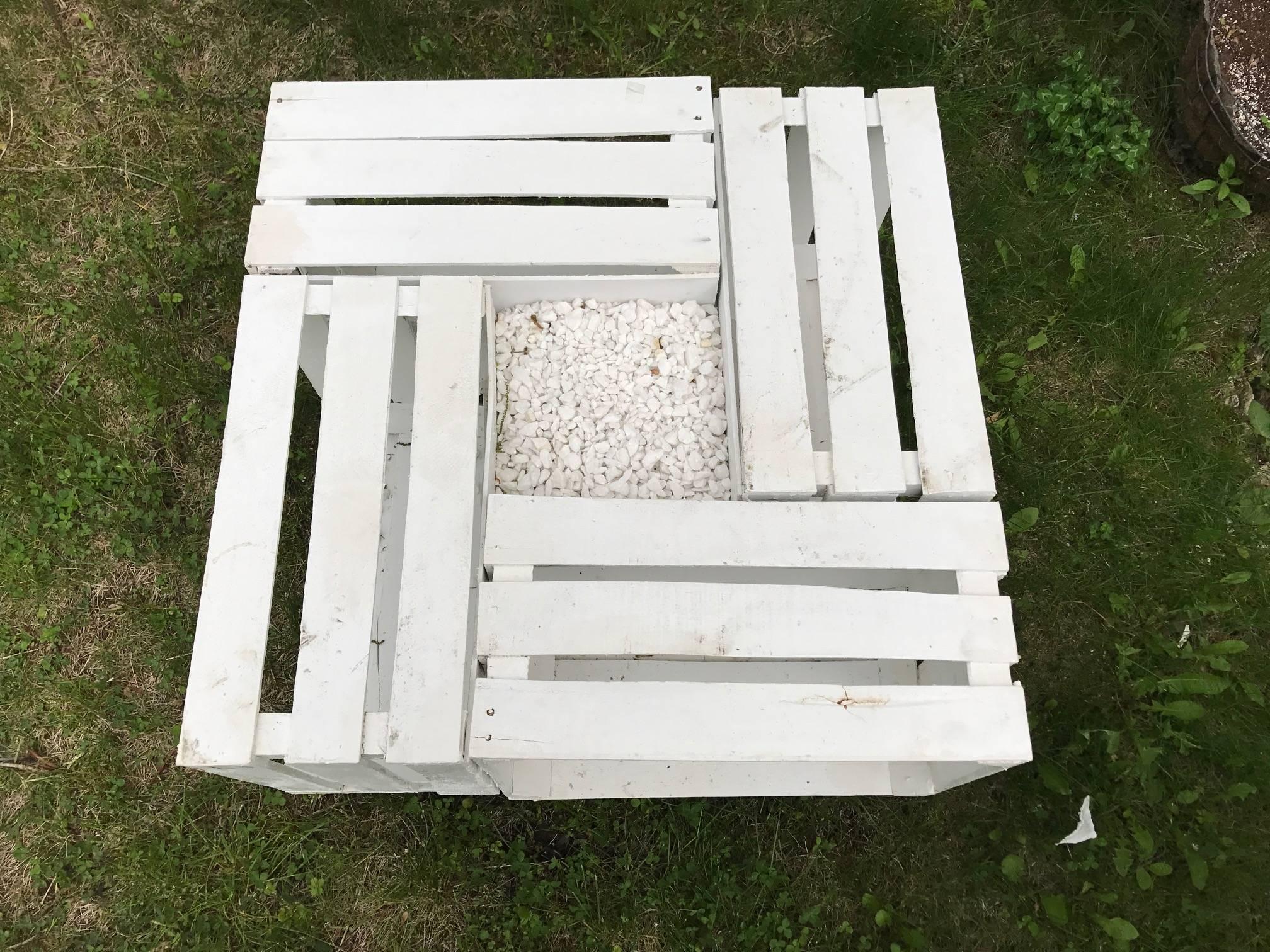 Handmade outdoor pallet wood painted white with gravel center table. This has a cool shape and interior shelves. A great rustic outdoor addition.
