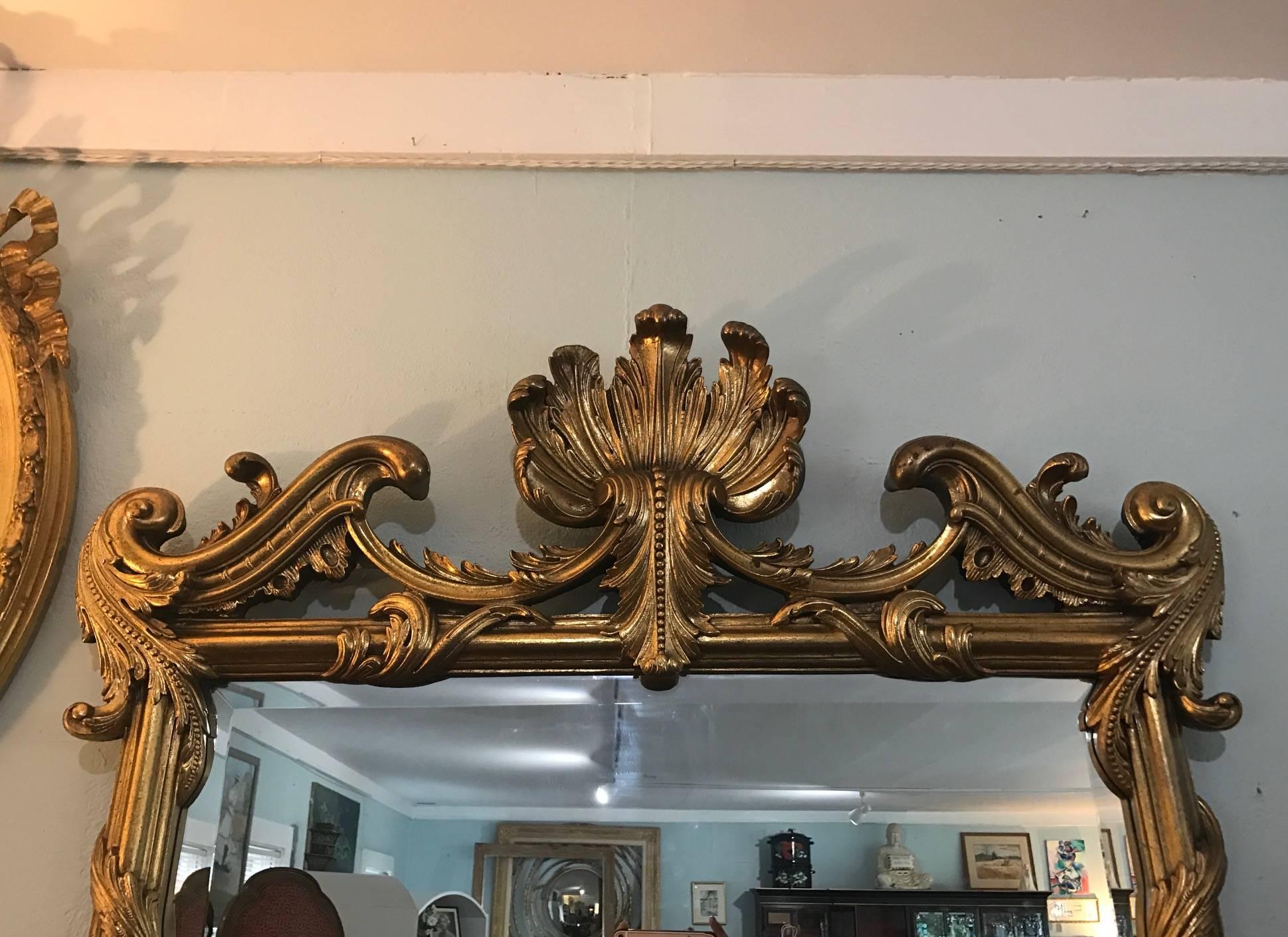 La Barge handcrafted mirror hand-carved and gilded seashell design wall mirror. A finely carved French Hollywood regency style wall or console mirror. Beautiful seashell design and scroll work. La Barge mirrors are designed by Well Traveled