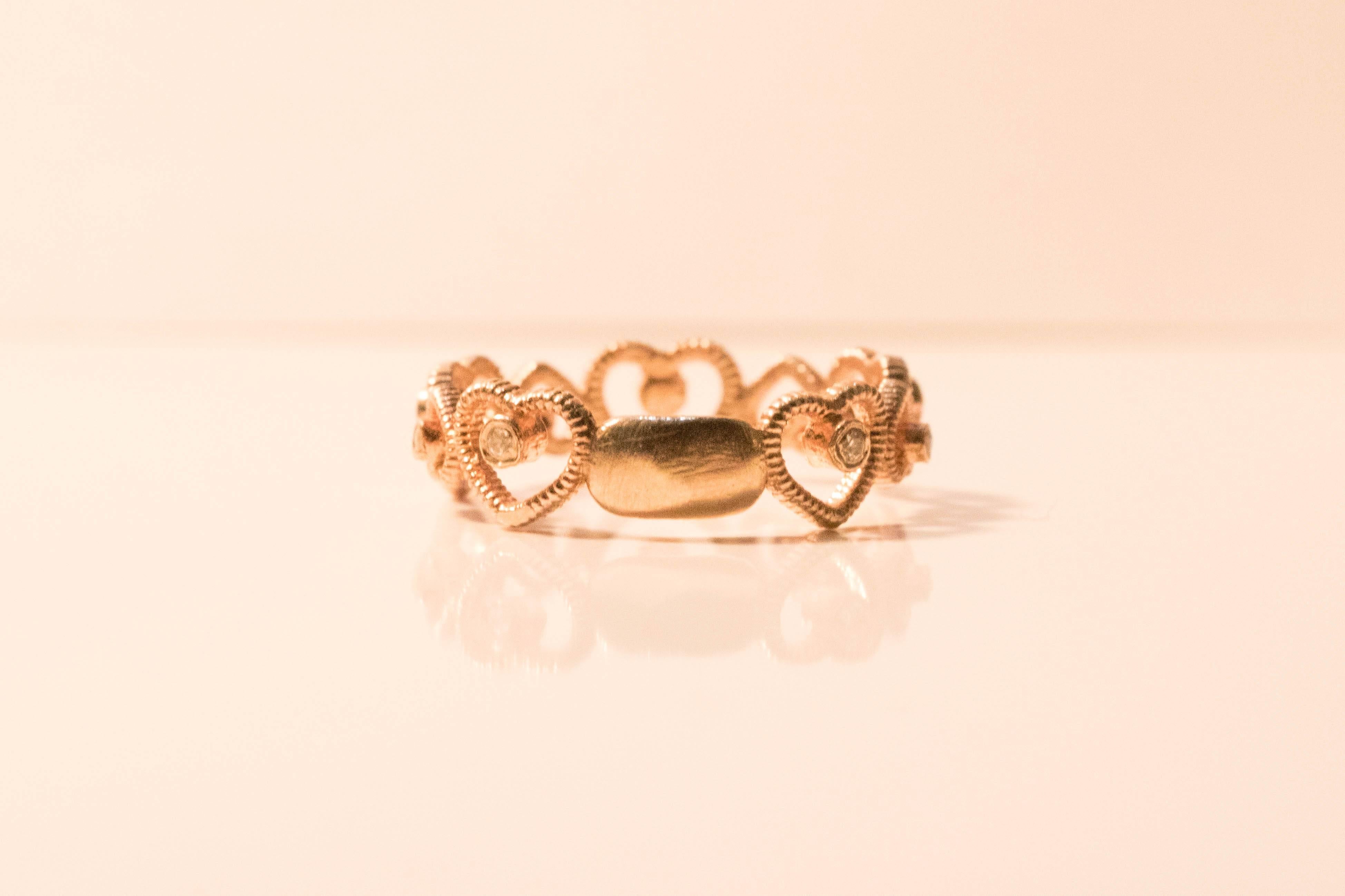 Vintage circle of heart's Swavorski ring. You've got my heart vintage ring. Small zirconia chips in every heart! A rose plated .925 beauty. Express your love for that special someone.

Size 7.