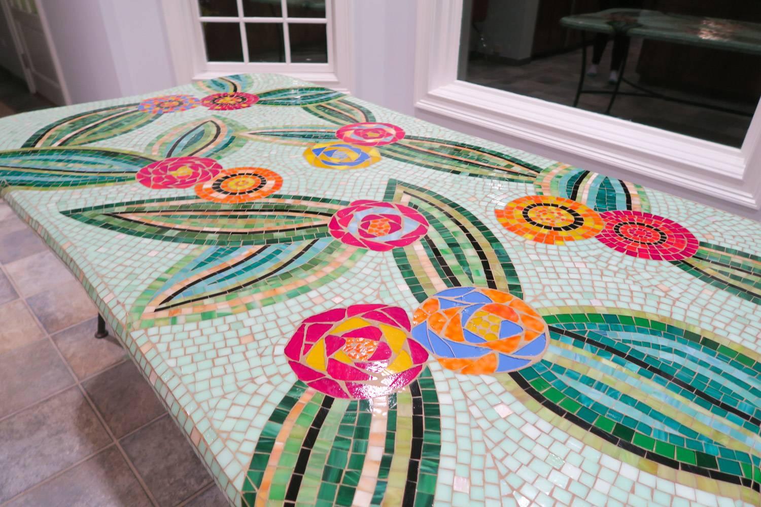 Colorfully beautiful mosaic dining table custom-made! A beautiful Array of blues, reds, oranges, sea glass greens, taupe and sky - This is a one of a kind custom piece. Wrought iron base. Spectacular. Seats 8 - 10.