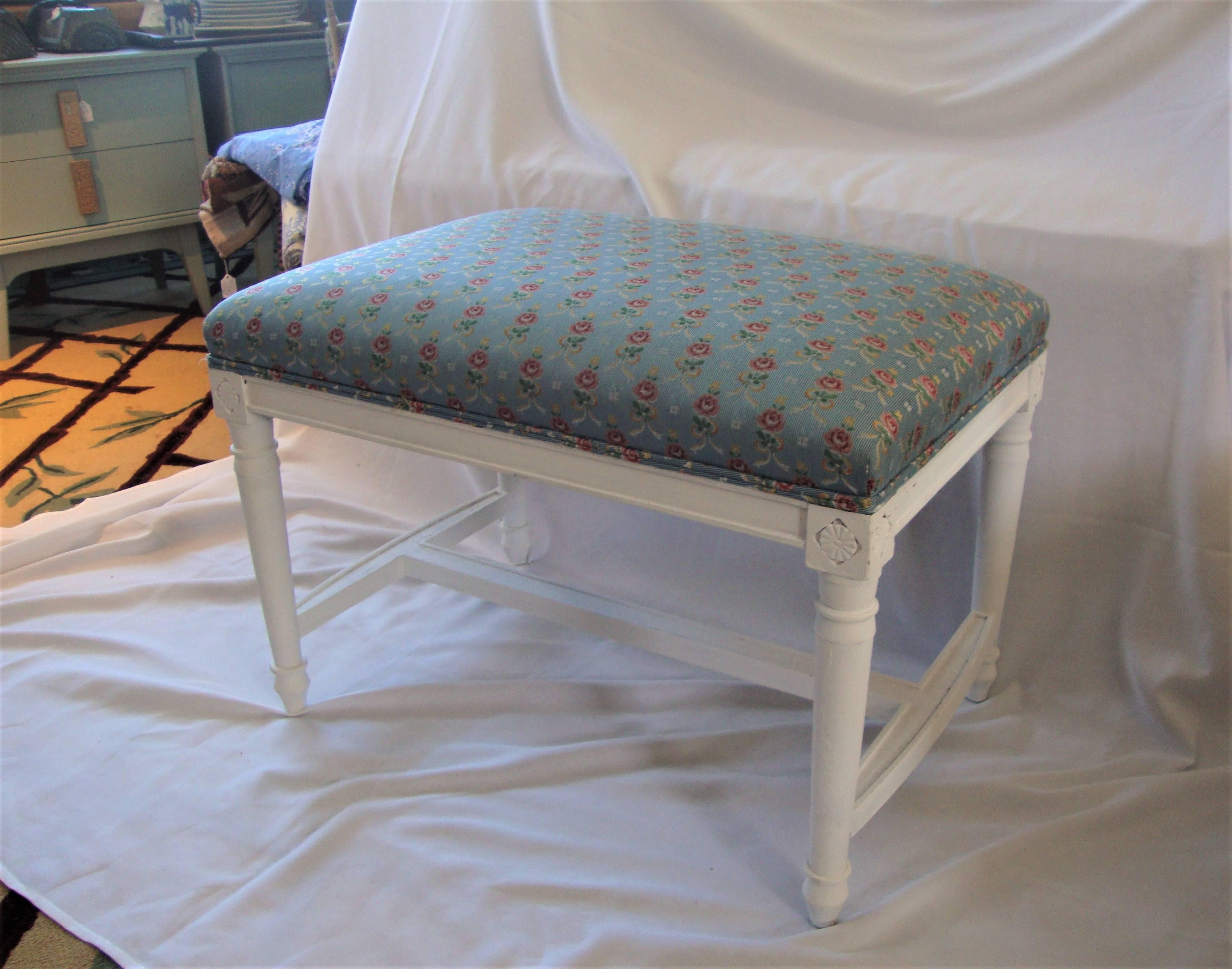 A Fantastic Painted Pure White Louis XVI Bench Displaying Beautifully Clean Sea Blue Backdrop with Pretty Pinks and Whites Flowers -- adding a touch of French Country.  Medallions are carved in the legs - giving more character to these fabulously