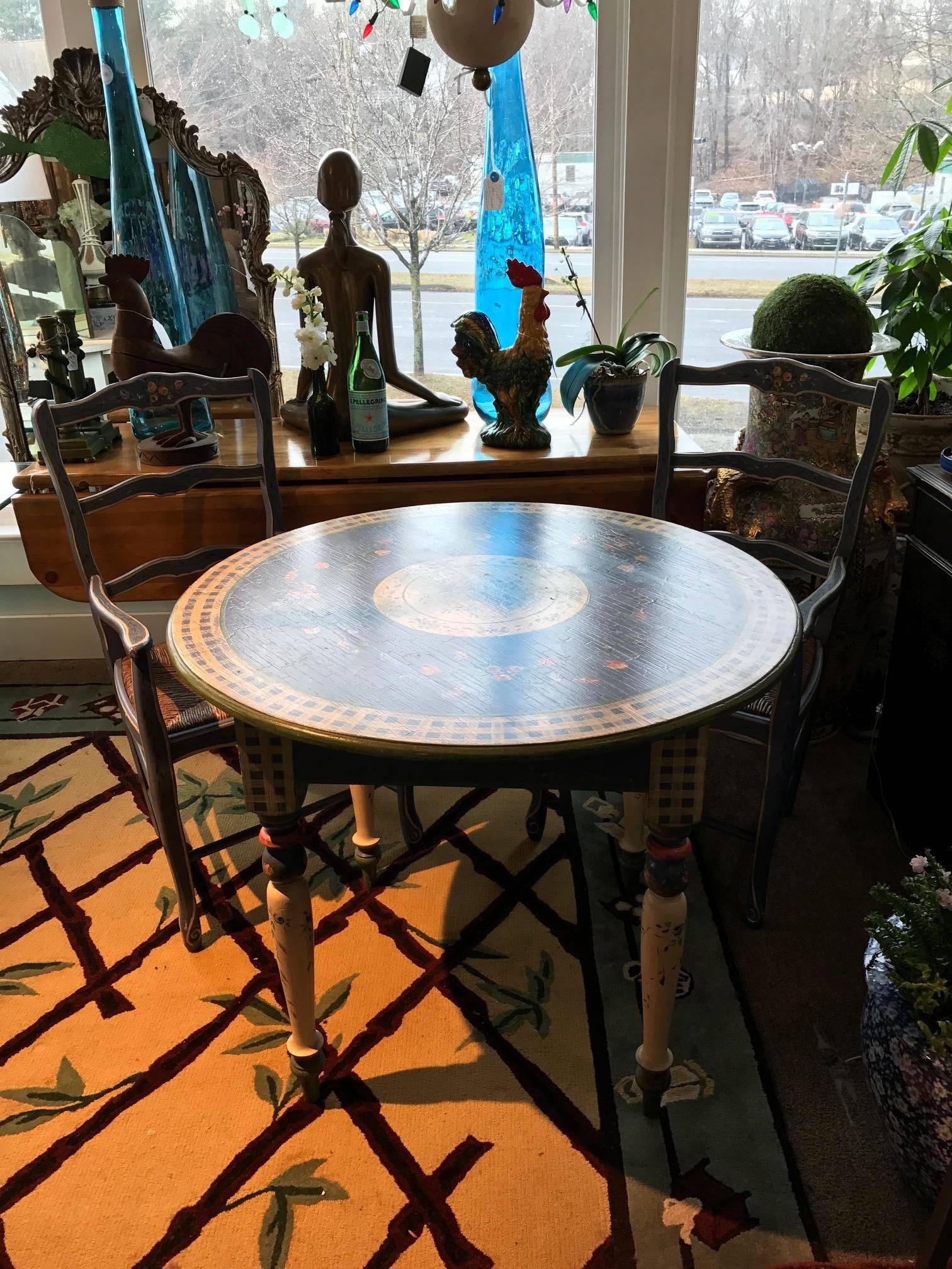 Fabulous shabby chic hand-painted Persian blue breakfast table and two chairs, shabby chic or farmhouse at it's finest. Little roses and vines adorn this uniquely pretty table and chairs.

Dimensions:
H 37 x L 21 x D 17.5 x SH 17.