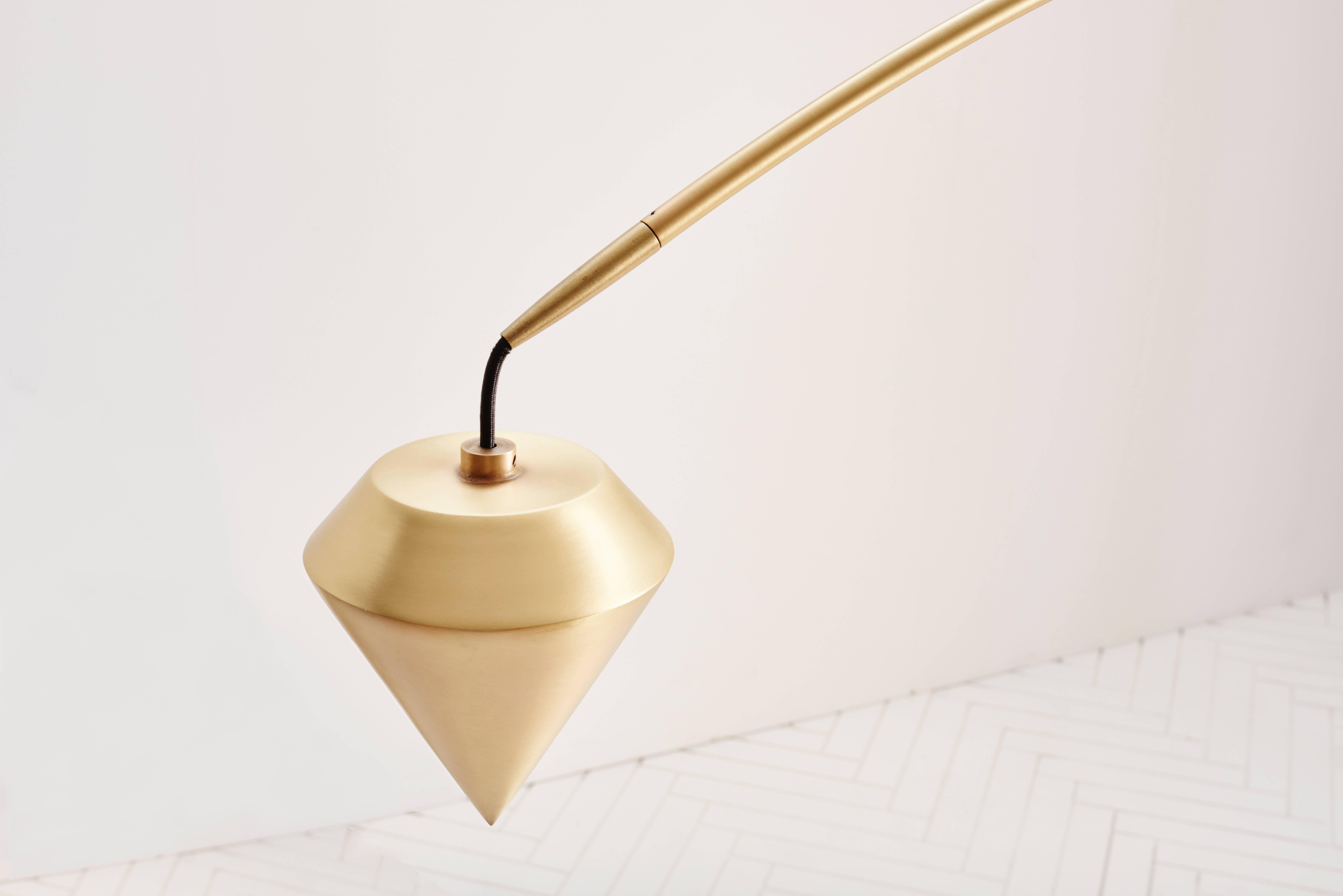 Comprised of a beautifully tapered arc held in perfect balance by a white glass orb and our signature large plumb weight. Available in brushed brass and oil-rubbed bronze (a rich warm black).

Custom sizes can be accommodated. Please note lead times