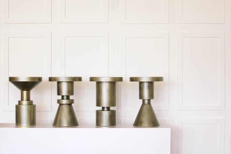 Like chess pieces dotted across a board, these sculptures can be placed throughout a room. Used as side tables or stools, they are made to work in series or alone. Metal stools are made from cold rolled steel, brass plated and finished with a hand