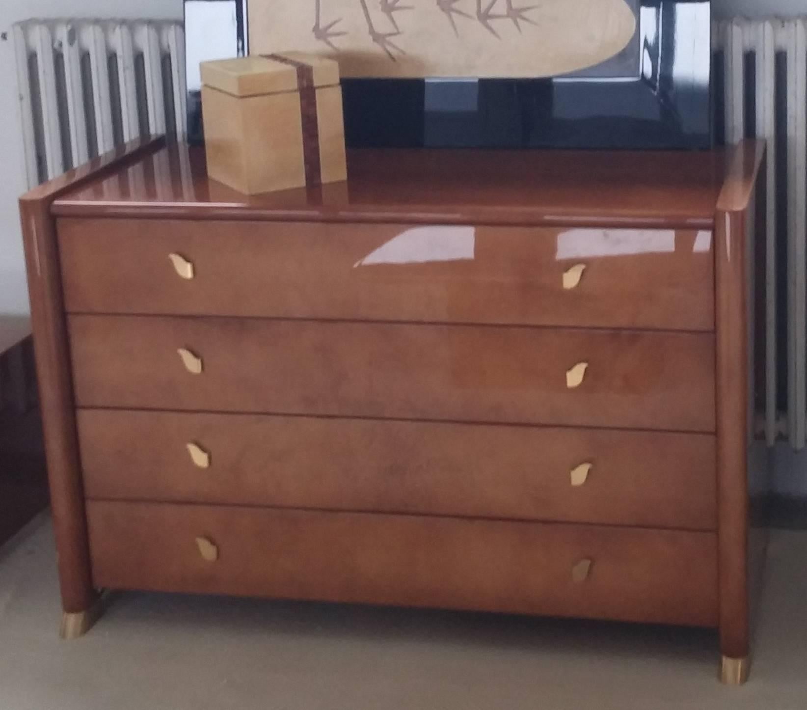 Bedroom set, Tura, almond parchment high gloss,
Italy 1990s, the wooden frame covered with almond color parchment,
with beautiful original brass feet and handles.
Size chest of drawers: 125 x 54 x 82 H cm.
Size night table (qt 2): 61 x 43 x 42 H