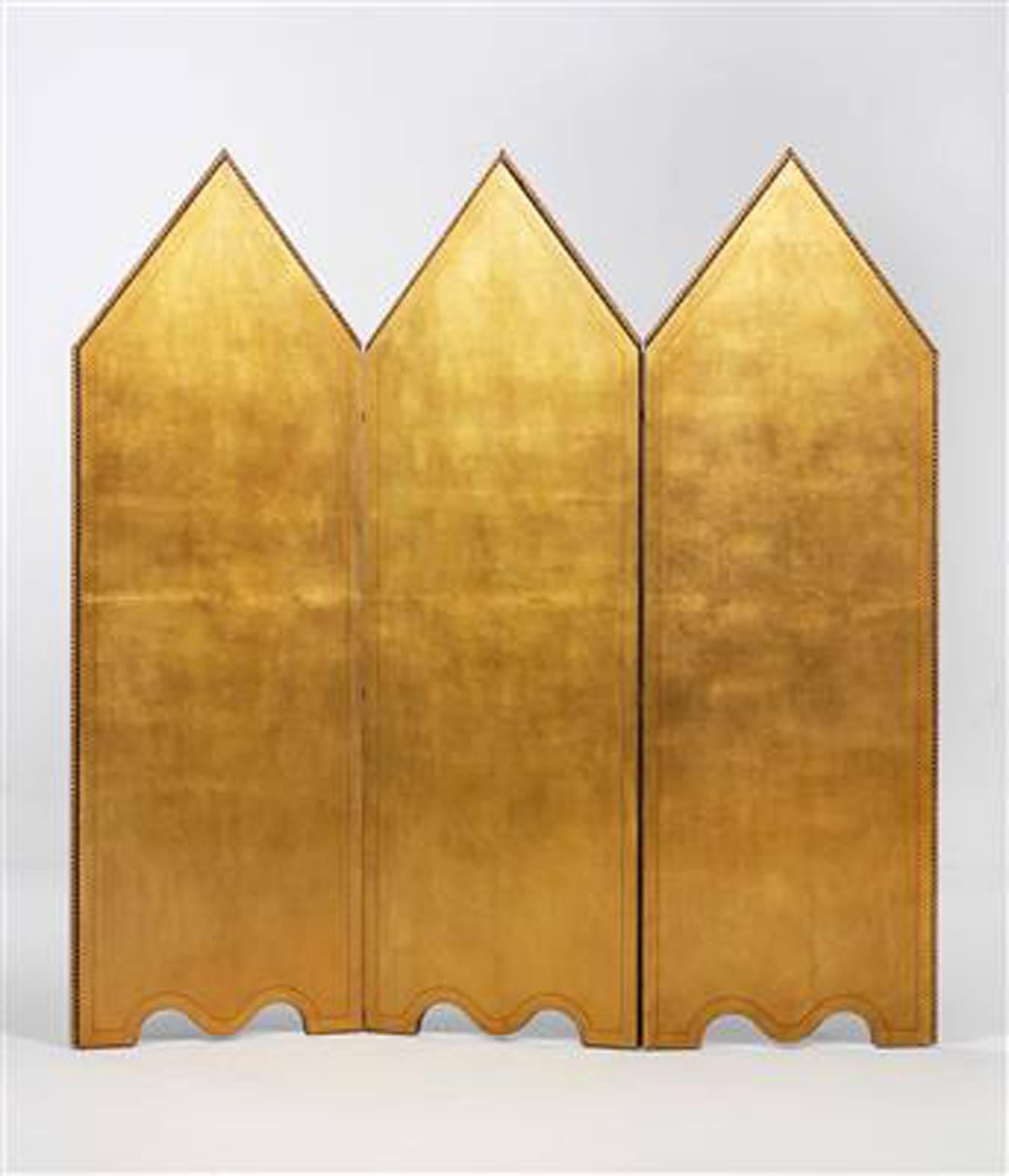 A “Galeoni” three‐fold screen, Aldo Tura,
Italy, 1980s, wooden frame, one side covered with parchment embellished with gold leaf, the other side covered with parchment featuring painted
decoration of Spanish ships, framed by a gilded border,