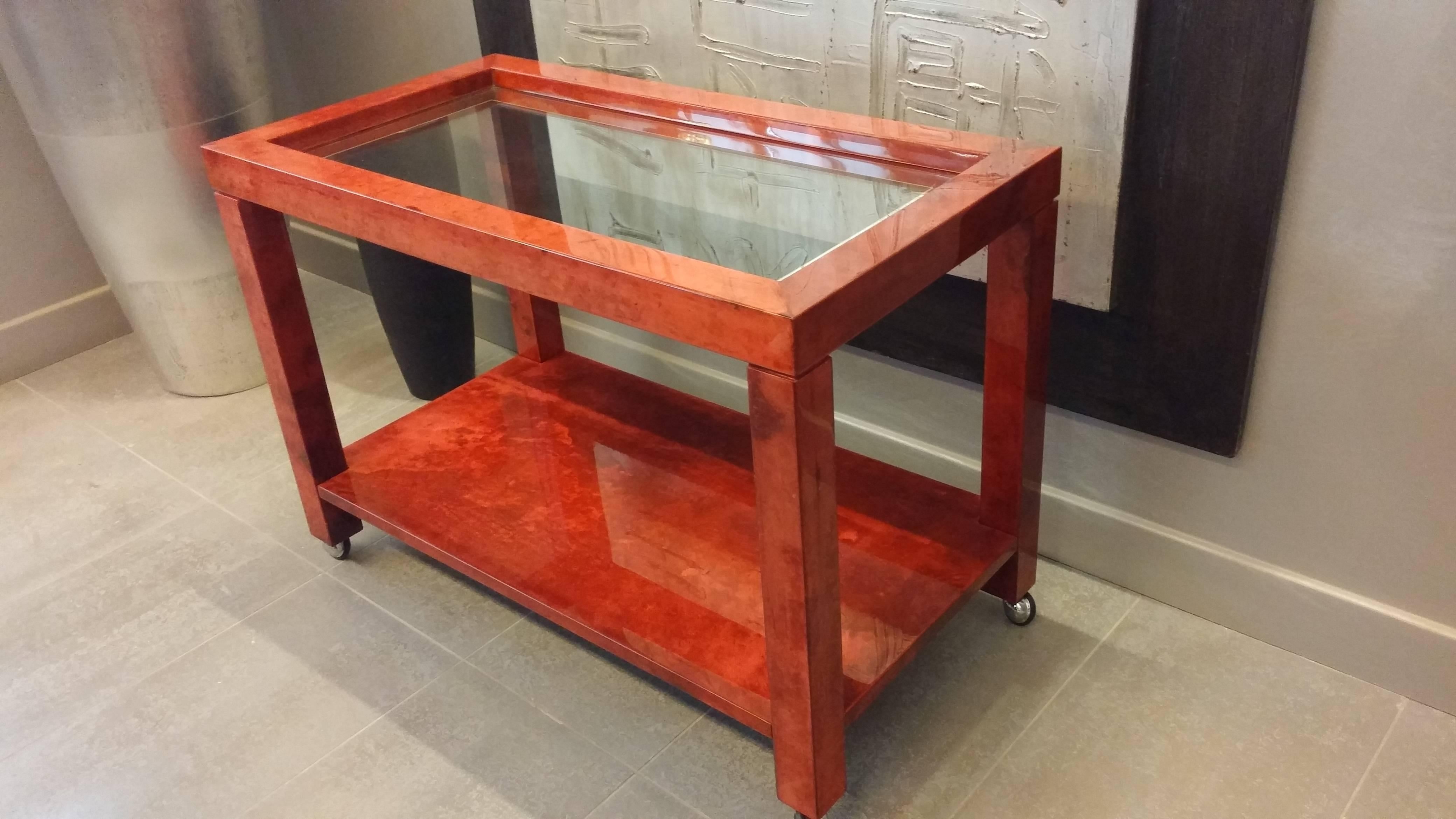 Red goatskin high gloss finish. With glass top. Very nice as a serving table cart or as a desk return.
Size 85 x 45 x H 60 cm.