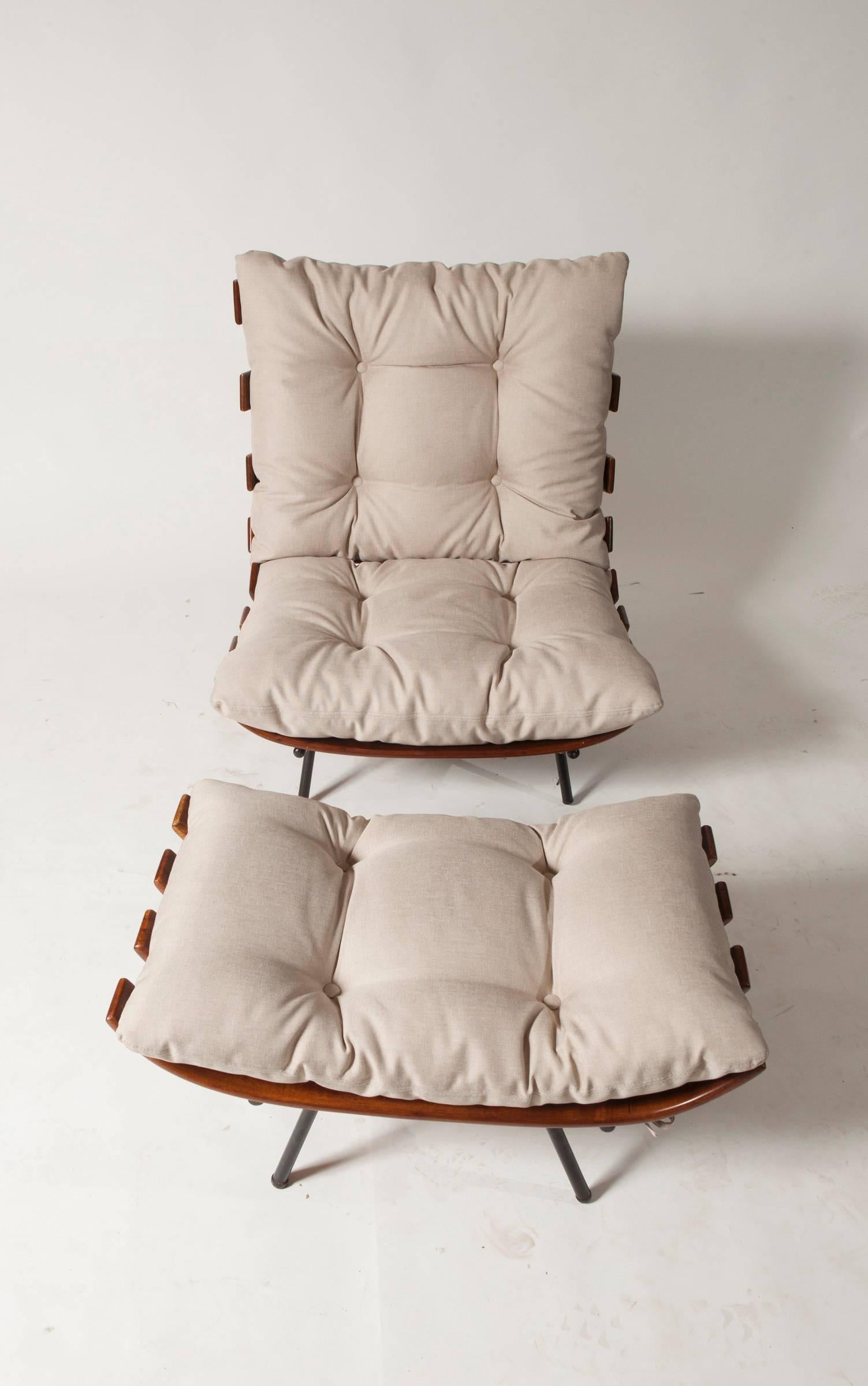A Carlo Hauner bone chair with ottoman with fabric cushions, iron painted structure.