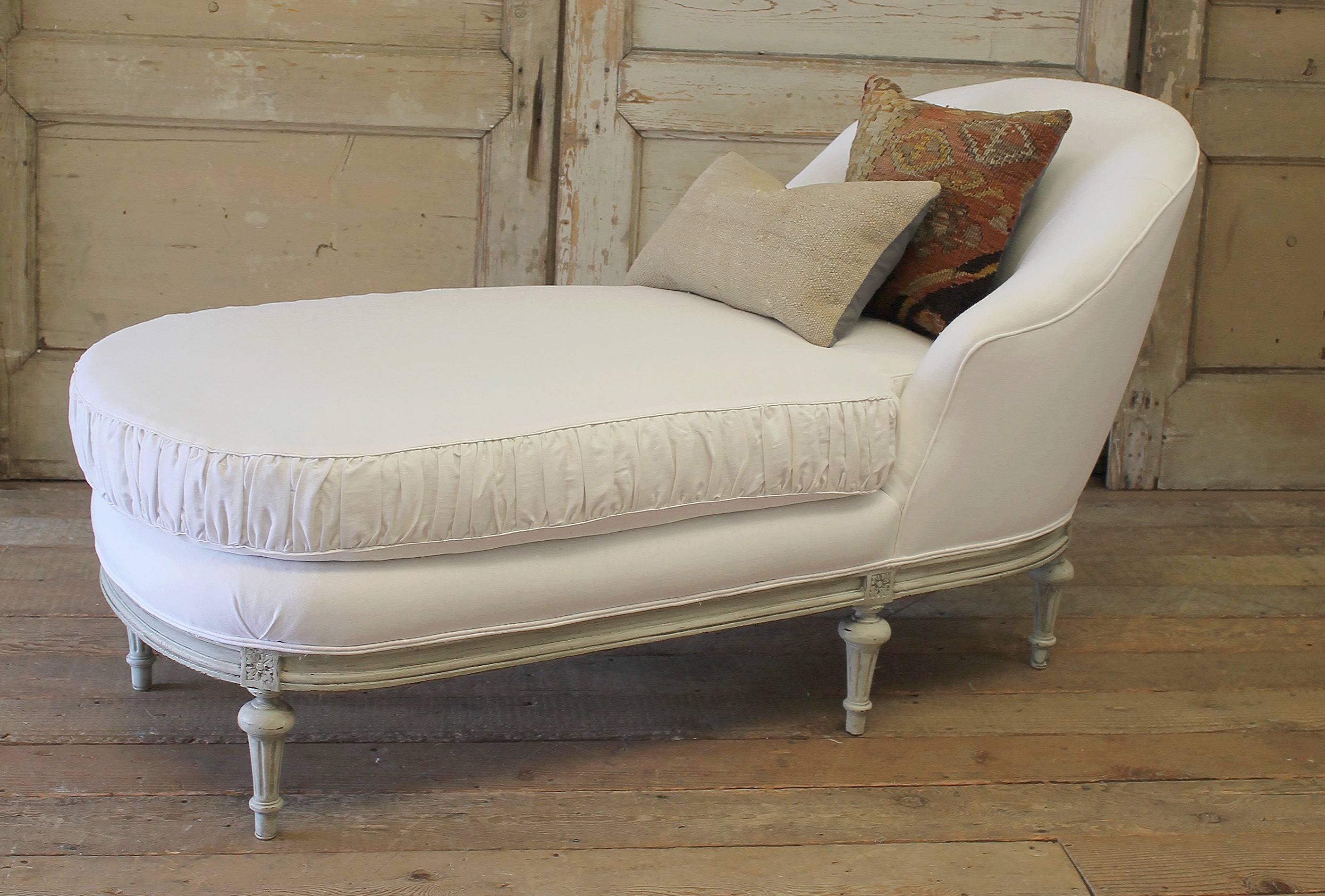 This antique French chaise longue has been painted in our dove grey, finished with a hand rubbed patina, and faux glaze to give the look of a time worn finish. The legs are solid carved walnut, and are very solid and sturdy. 
The upholstery is a