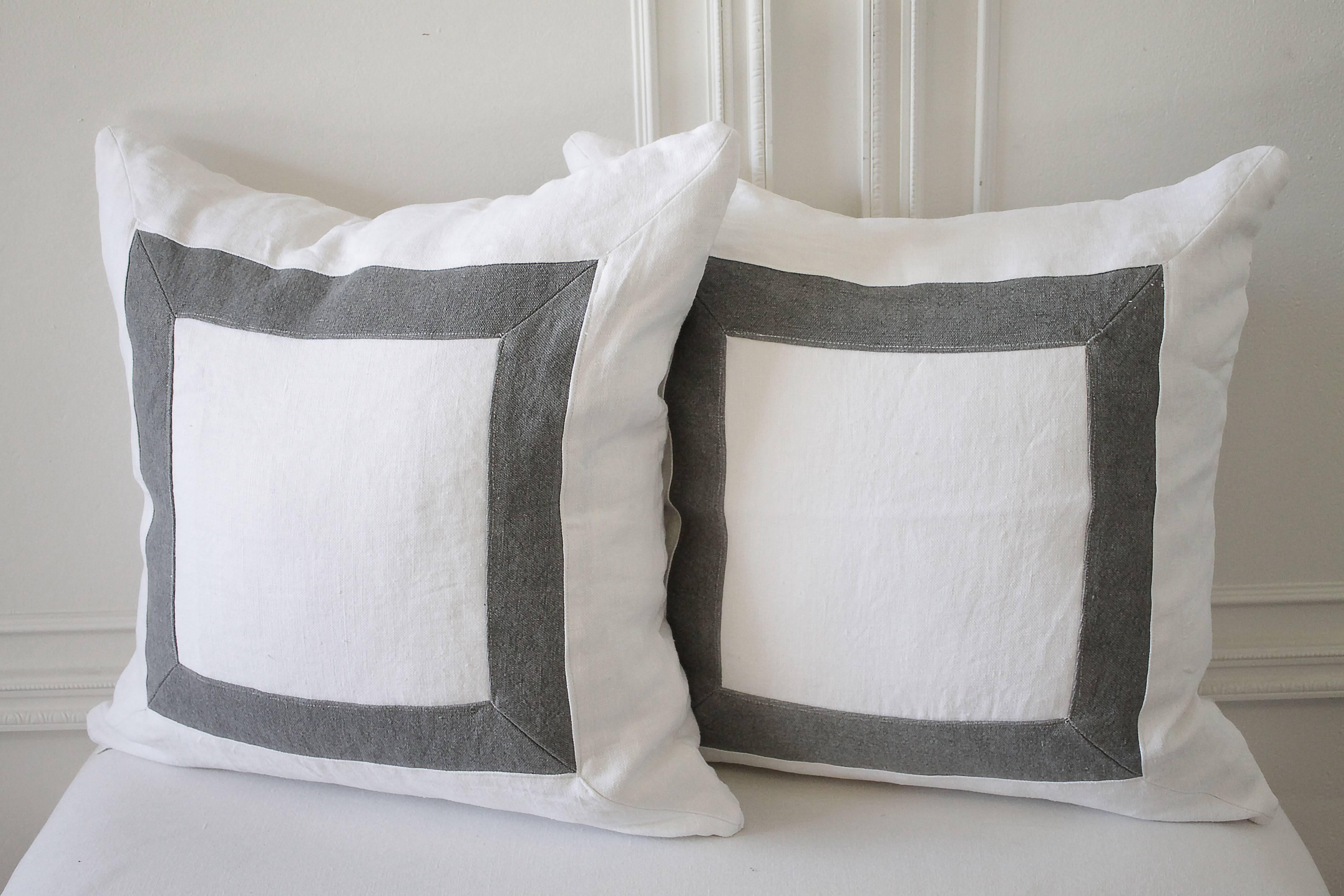 Custom-made in our workroom are these fabulous picture frame style linen pillows made with stone wash Belgian linen. Both front and back are finished with the same picture frame.
Linen is ultra pure white, with medium grey. 
Zipper
