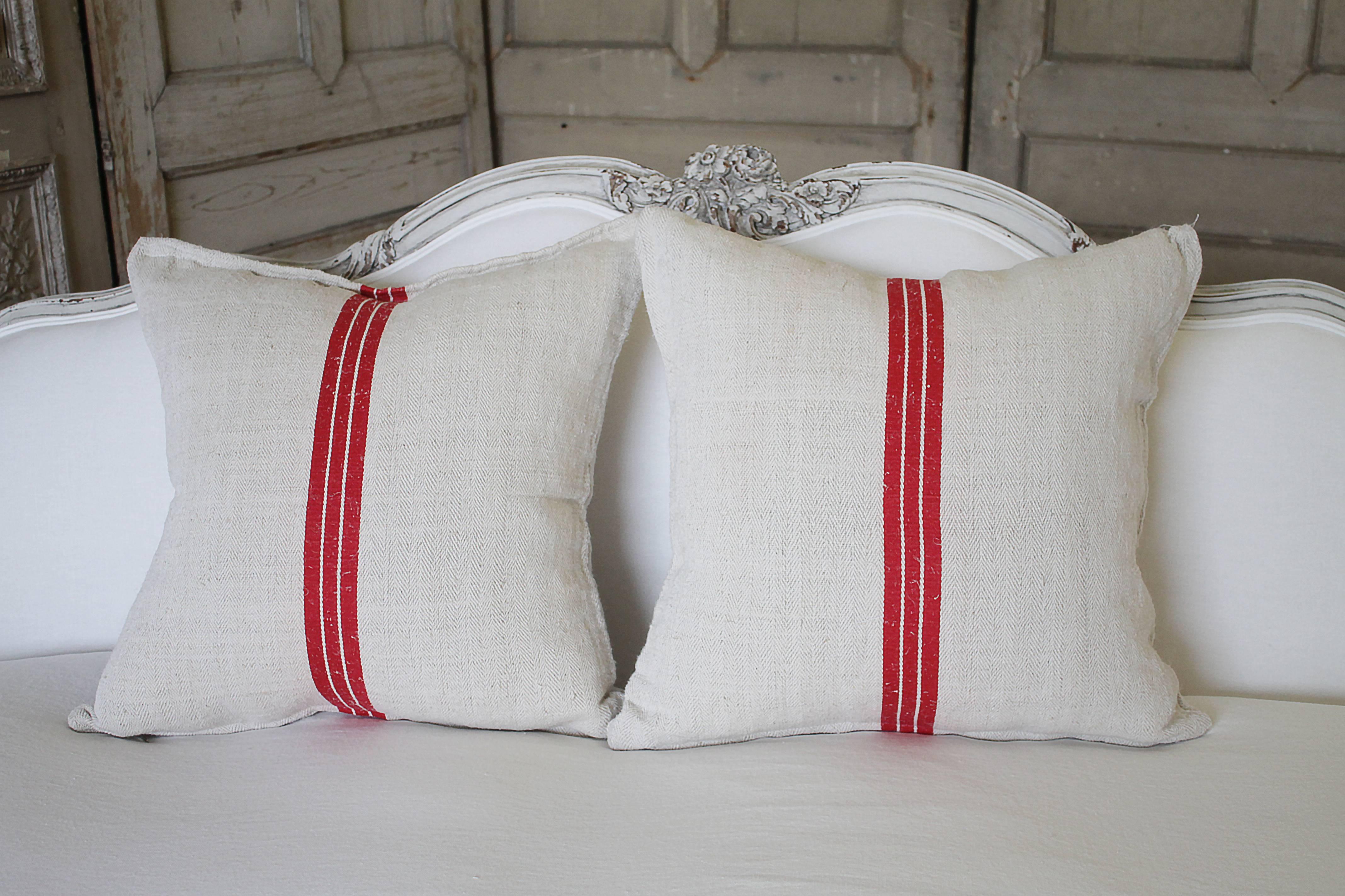 Beautiful set of pillows made from antique farmers grain sack, circa 1890-1920.
These are a light oatmeal color with a dark red triple stripe in the centre. The pillow have a chevron style weaved pattern if you look closely. Each pillow is finished