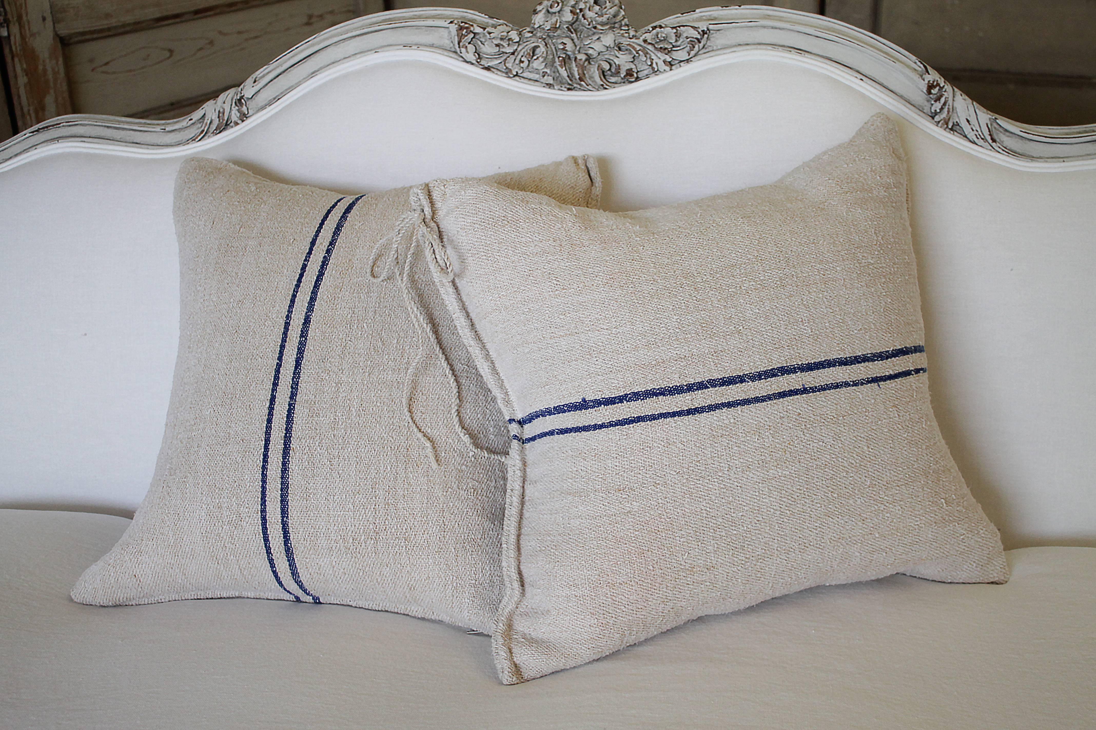 Beautiful set of pillows made from antique farmers grain sack circa 1890-1920.
These are a light oatmeal color with a dark blue double stripe in the center. Each pillow is finished with a zipper closure and overlocked. The original draw string tie