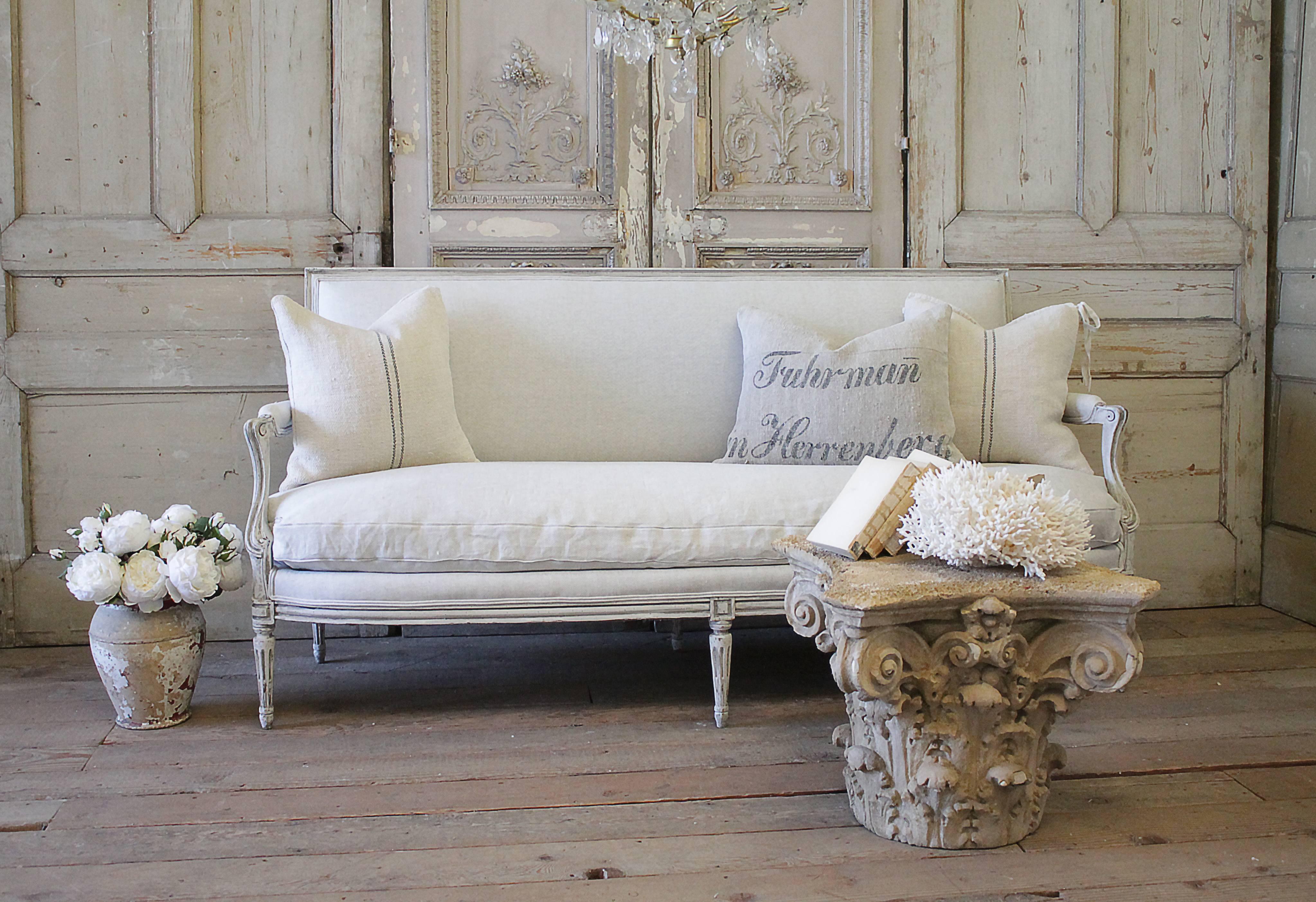 Beautiful Classic Louis XVI style sofa that has been refinished in our oyster white finish, with subtle distressed edges, and finished with an antique patina.
The color is a light grey tone. The upholstery is a light natural Belgian linen, finished