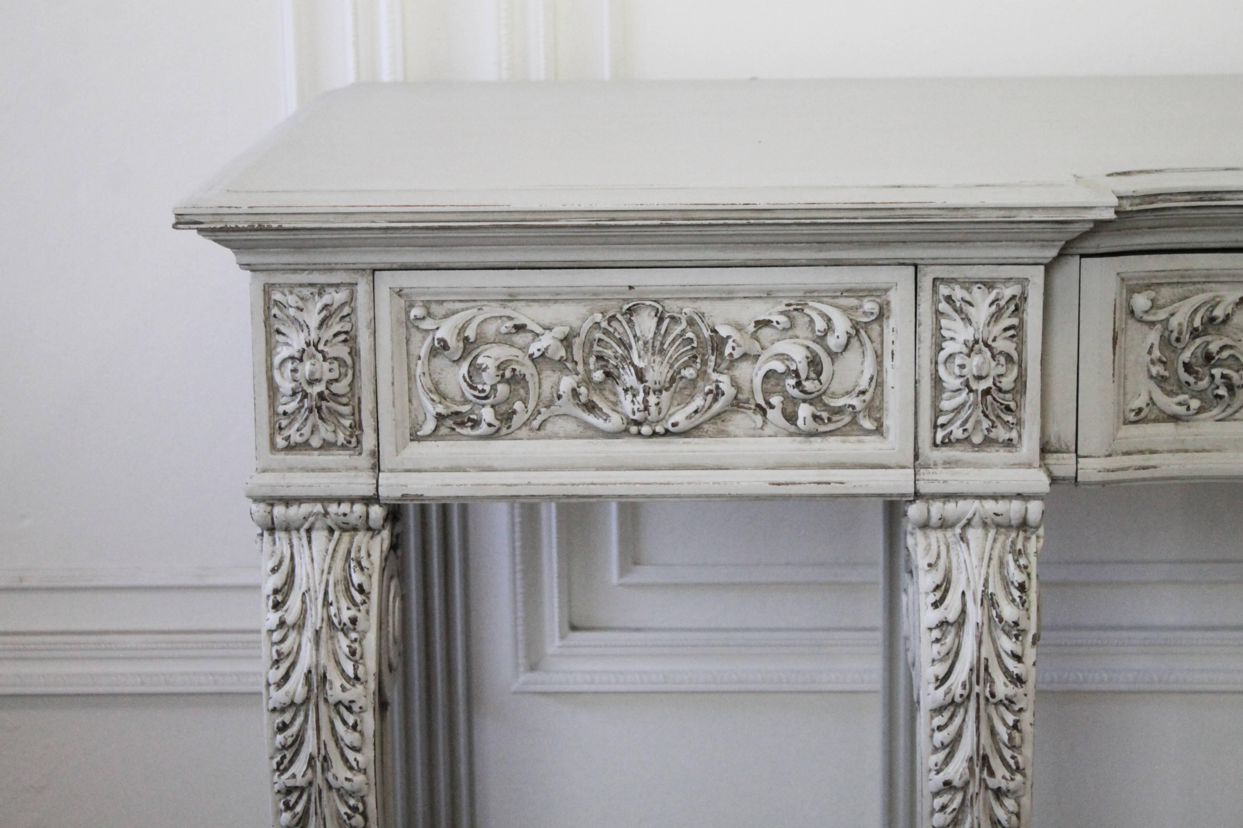 Constructed of solid walnut, with intricate carved clam shell, Rococo style carvings, and corbel shaped legs. This large wall server has three working drawers, constructed of solid wood, and dovetail finish.
The paint is a soft oyster white, with