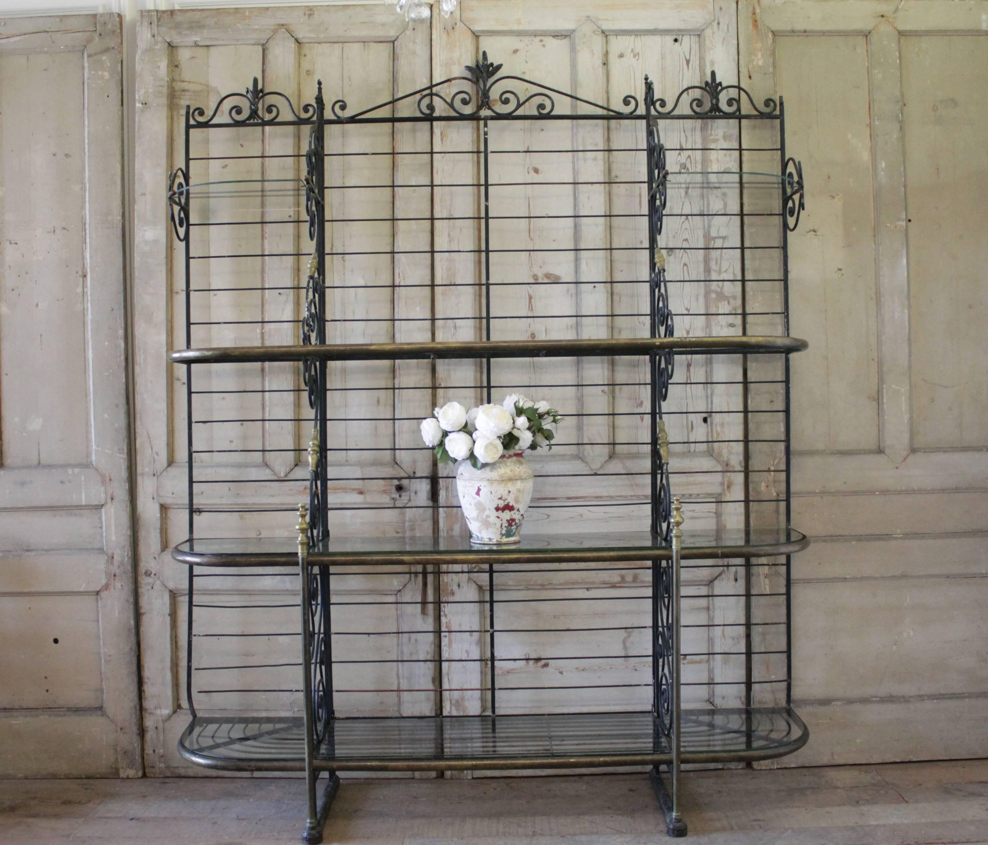 Early 20th century French bakers rack by Perfit Fils Ltd., Paris, France. Item features a heavy scrolling wrought iron and polished brass frame, numerous shelves with iron supports with the makers mark found on the lower iron support. This large