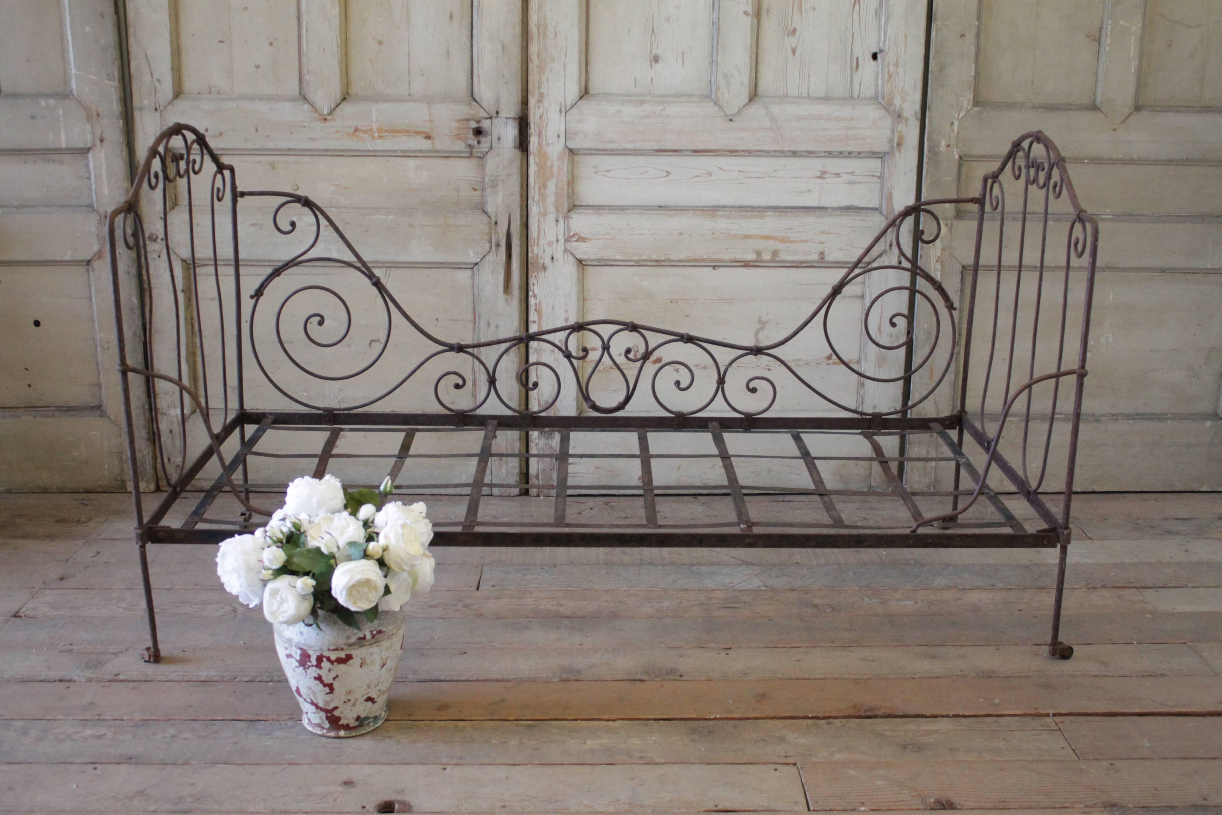 Beautiful antique French Campaign bed in dark antique bronze finish. The solid iron daybed folds down flat for easy storing and transporting. When opened the bed is very sturdy. We have included a custom piece of foam for this daybed, and can slip