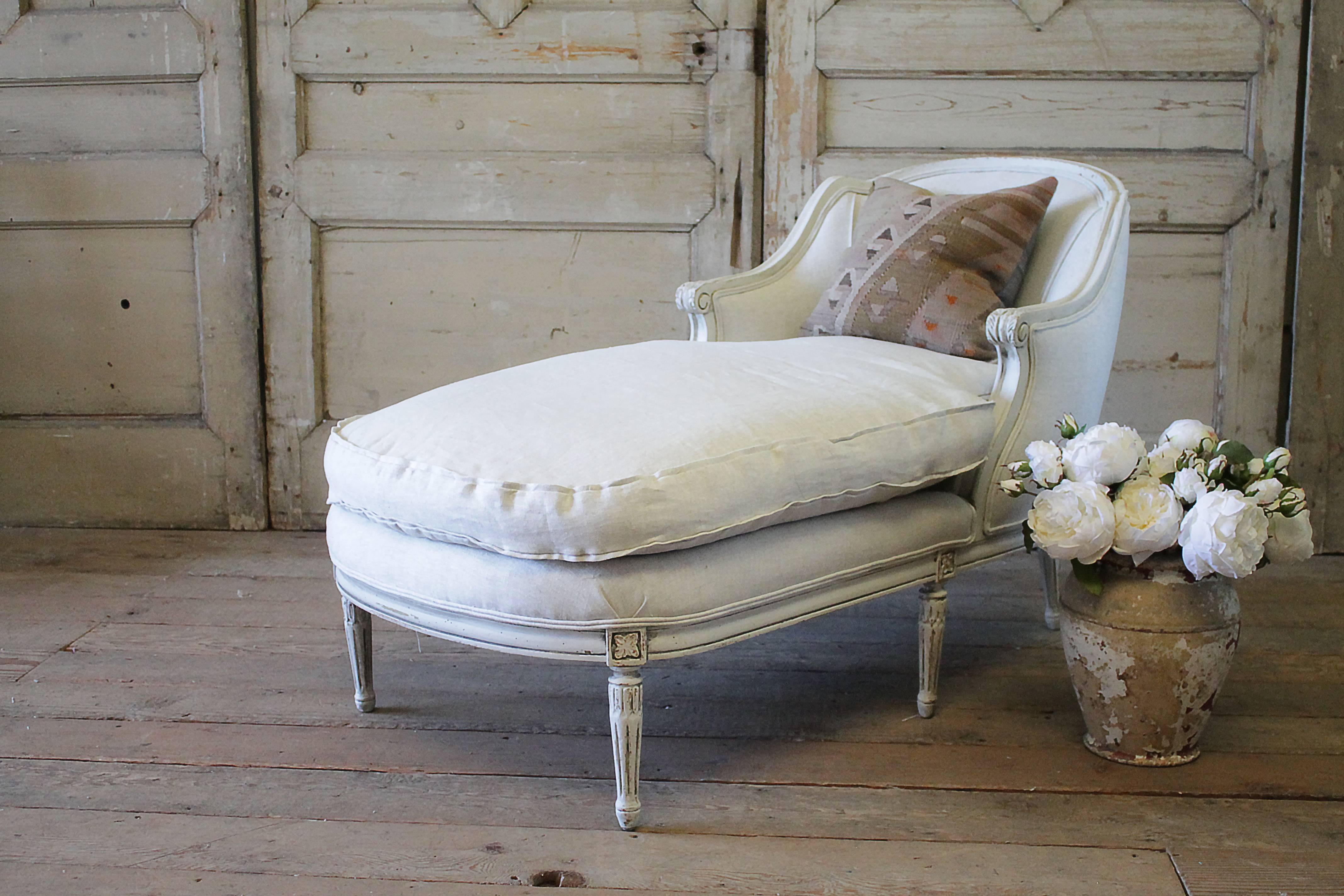 Antique chaise longue has been painted in our oyster white finish. Our finish has a slight greyish tone, with subtle distressed edges, and finished with an antique glazed patina.
Reupholstered in a natural Belgian linen, finished with a double welt
