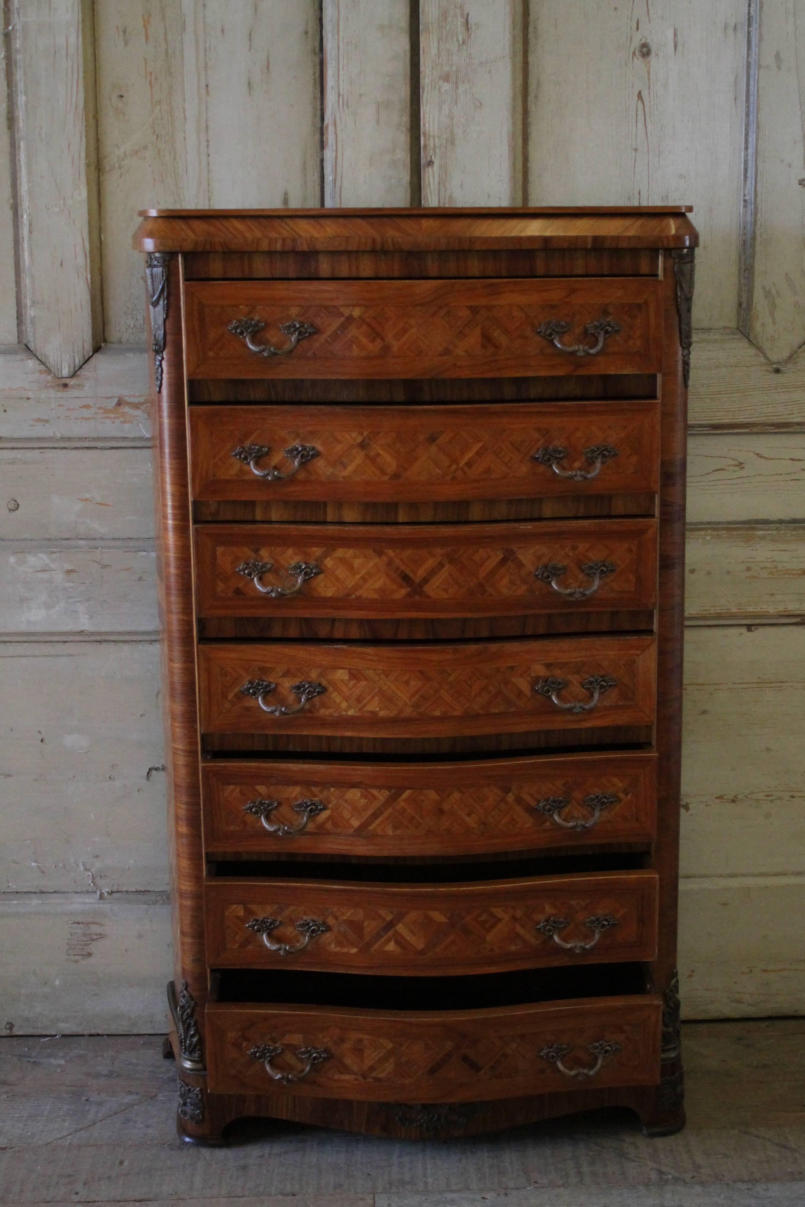 Beautiful lingerie chest with decorative diamond pattern inlays, bronze-mounted ormolus and pulls. This seven drawer chest drawers open and close with ease, and have a nice dovetail finish. Overall in good condition, some areas of the inlay has a