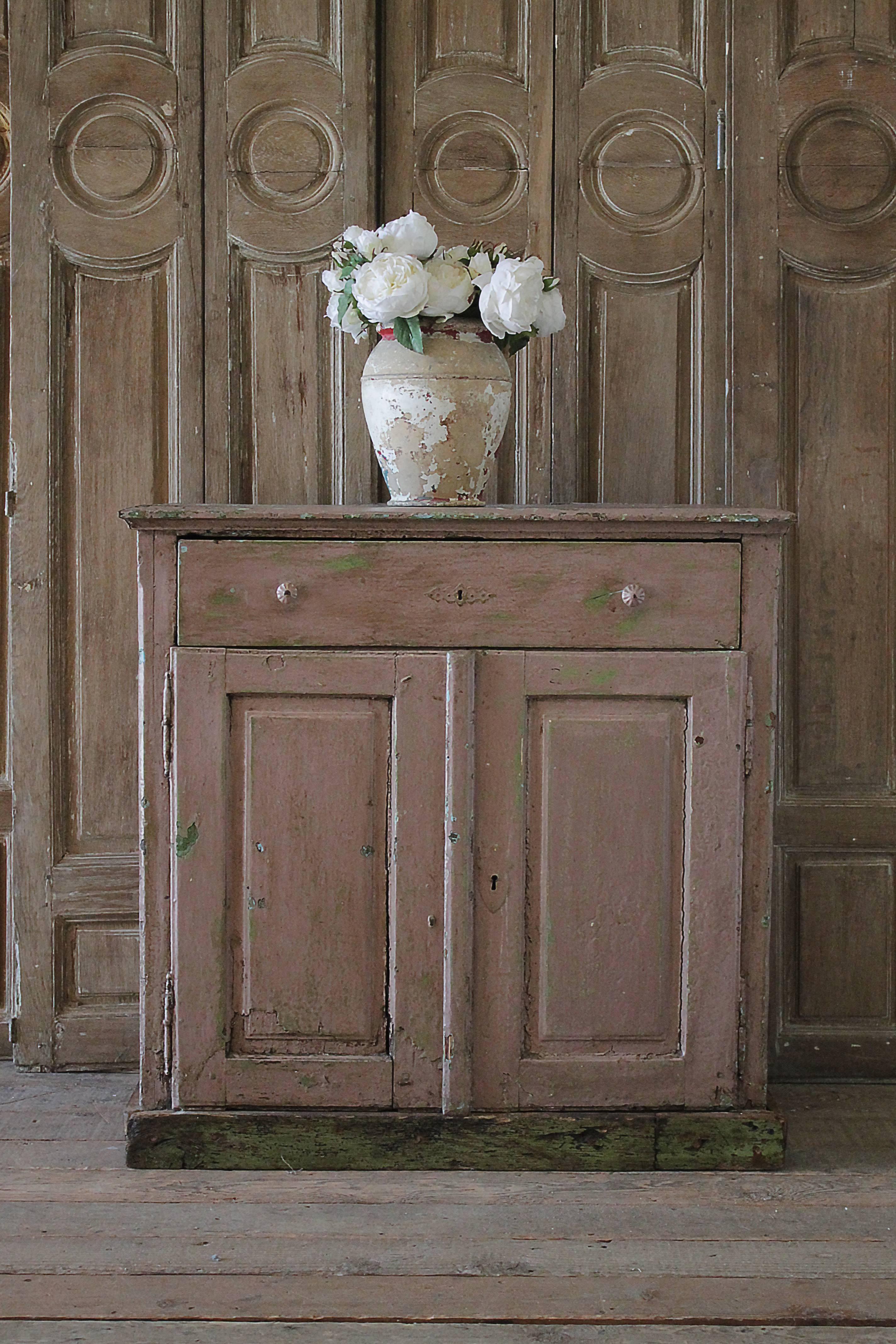 Original painted cupboard in soft muted pink, with green paint showing through. This has one working drawer with two cupboard doors that open fully, they do not lock.
Measures: 40
