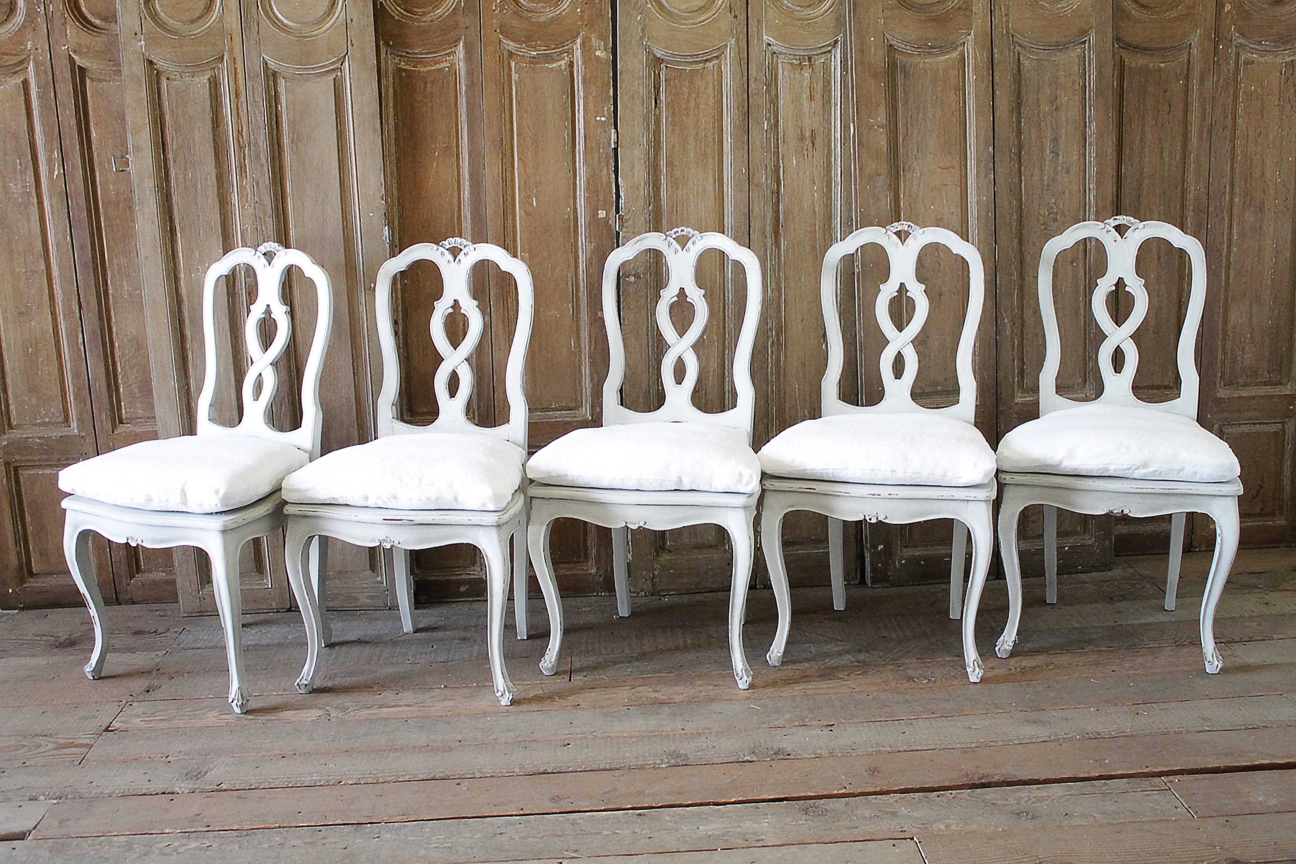 Lovely set of ten Italian carved dining chairs with cane seats, and a custom-made down cushion that we slip covered in 100% pure Belgian Linen. The slip covers have been pre washed, and have a hidden zipper closure.
Each chair is solid and sturdy,
