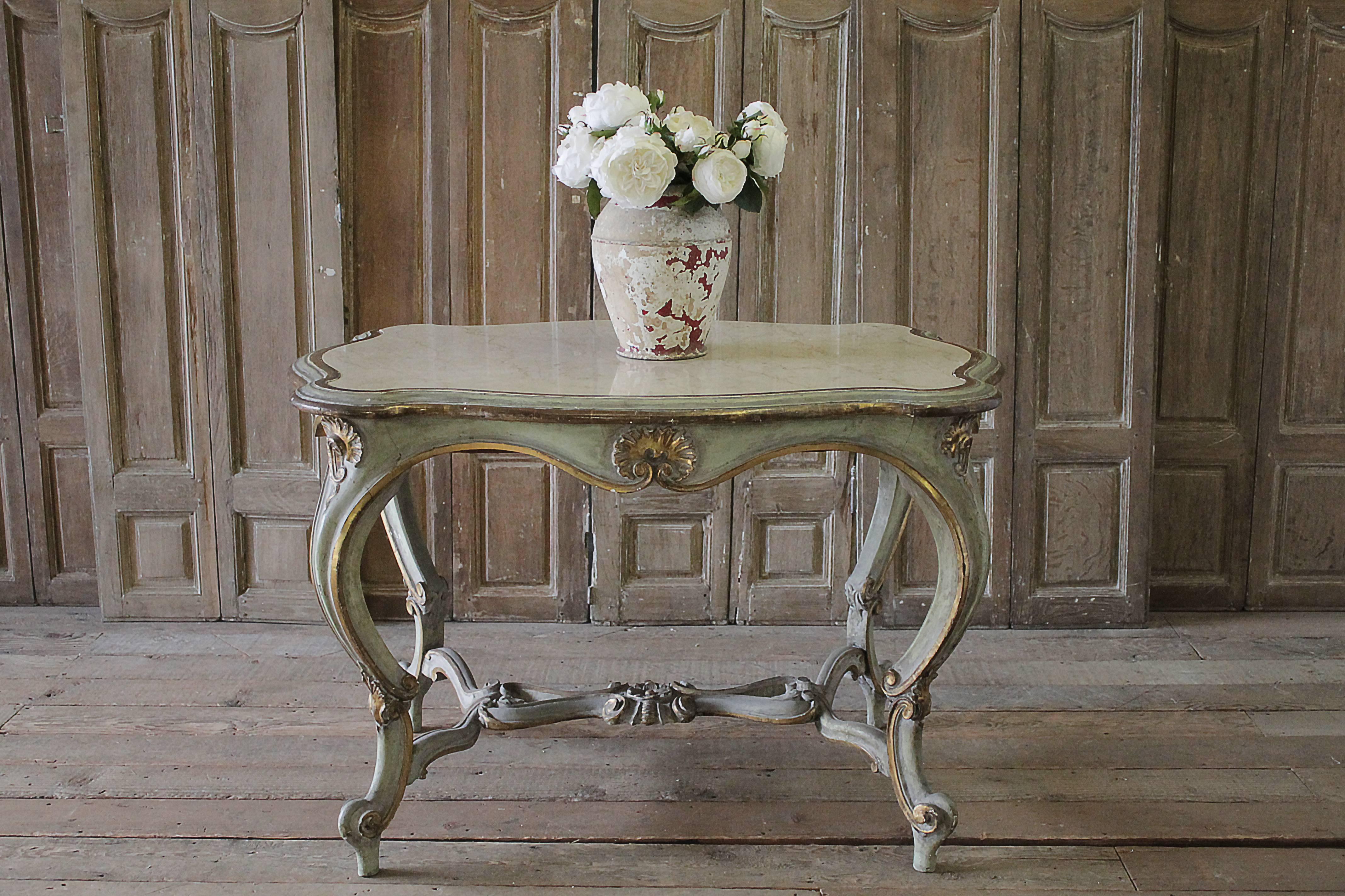 Lovely antique French Louis XV carved and painted center table with marble inset top. Original painted finish in soft greenish-grey with gilt accents. Marble top is a cream color with taupe colored veins. Signs of use, scratches present. Marble