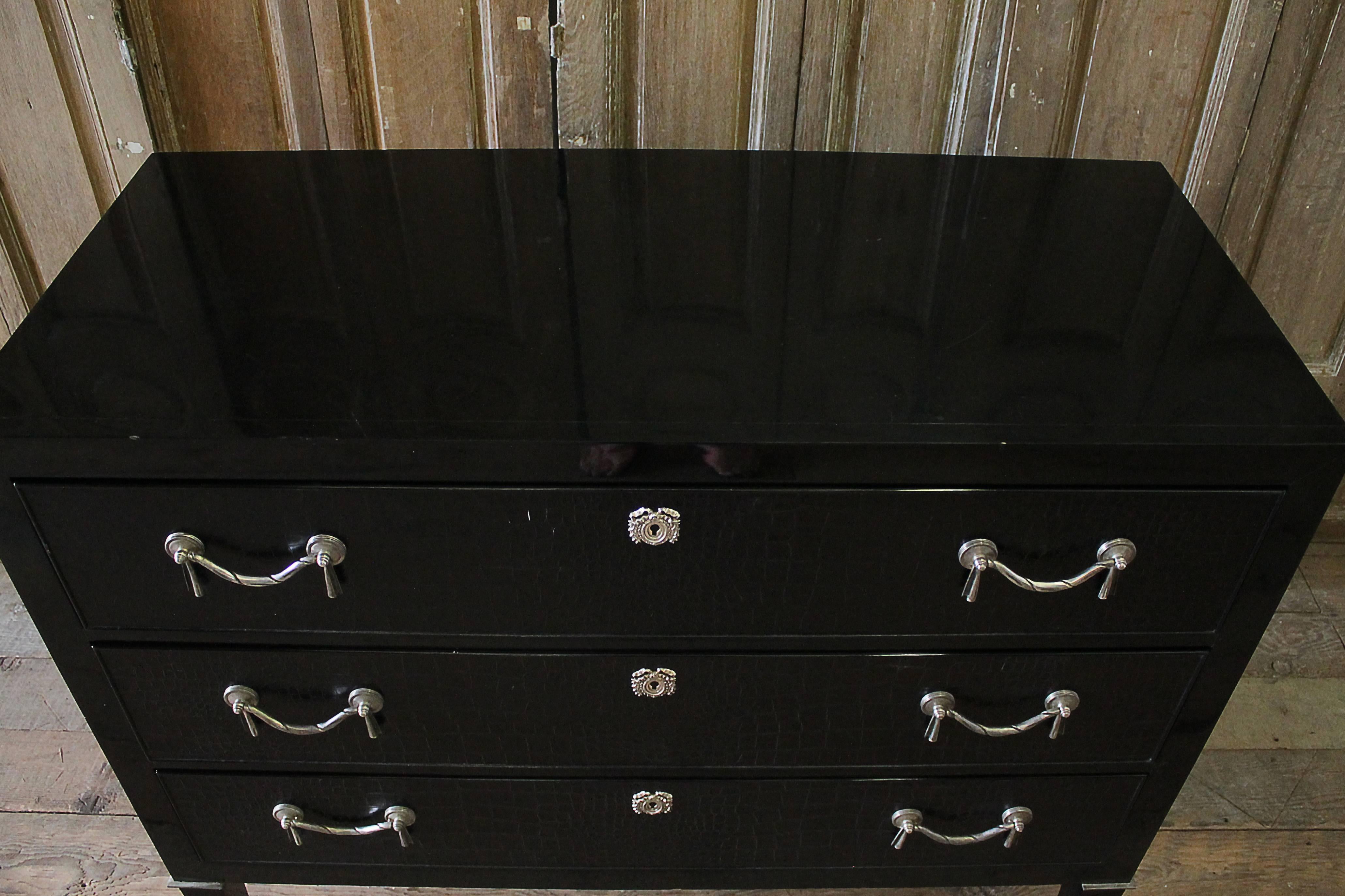 Brook street chest, black
RL Number: 7620-48 piano black with antique silver hardware
MSRP: $11,995
This modern interpretation of an Empire Revival dresser has faux crocodile drawer fronts with antiqued silver garland pulls and