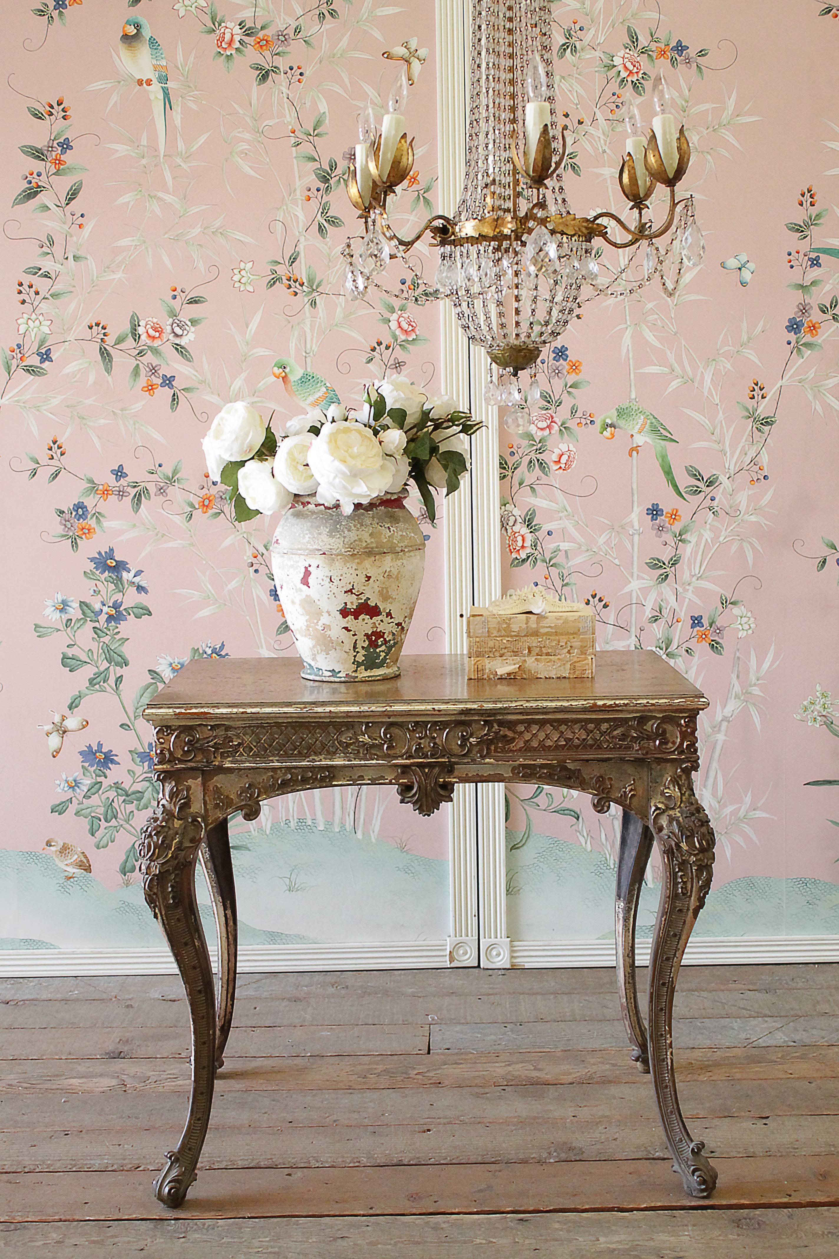 Early 20th century Louis XV style carved giltwood accent table with distressed patina.
Beautiful carved legs, and detailed apron, with faded gilt finish. The table legs are solid and sturdy, this table is great for an accent side table, center