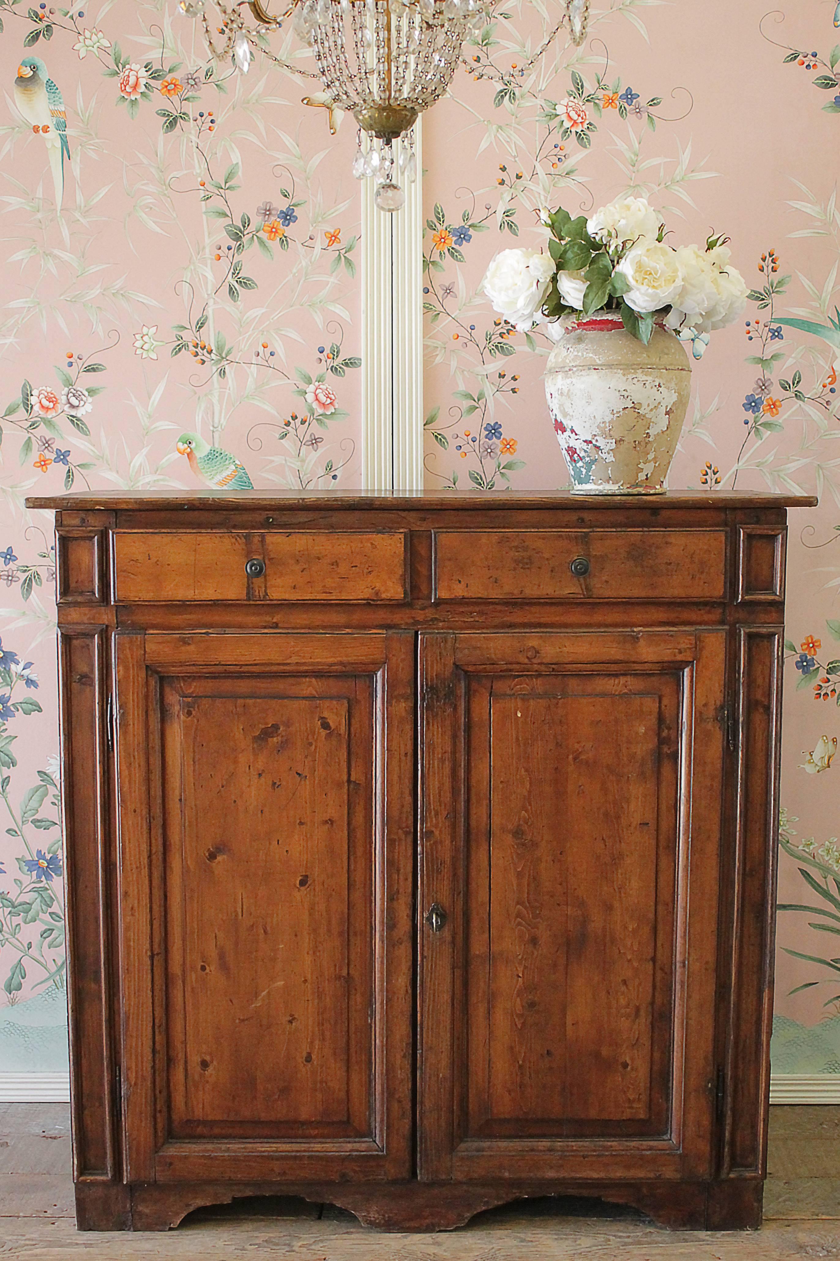 Beautiful antique country cupboard with two drawers and two doors. Drawers open and close with ease, the bottom doors do almost open up flat. Original working and locking key for the bottom doors is included.
Measures: 46.5