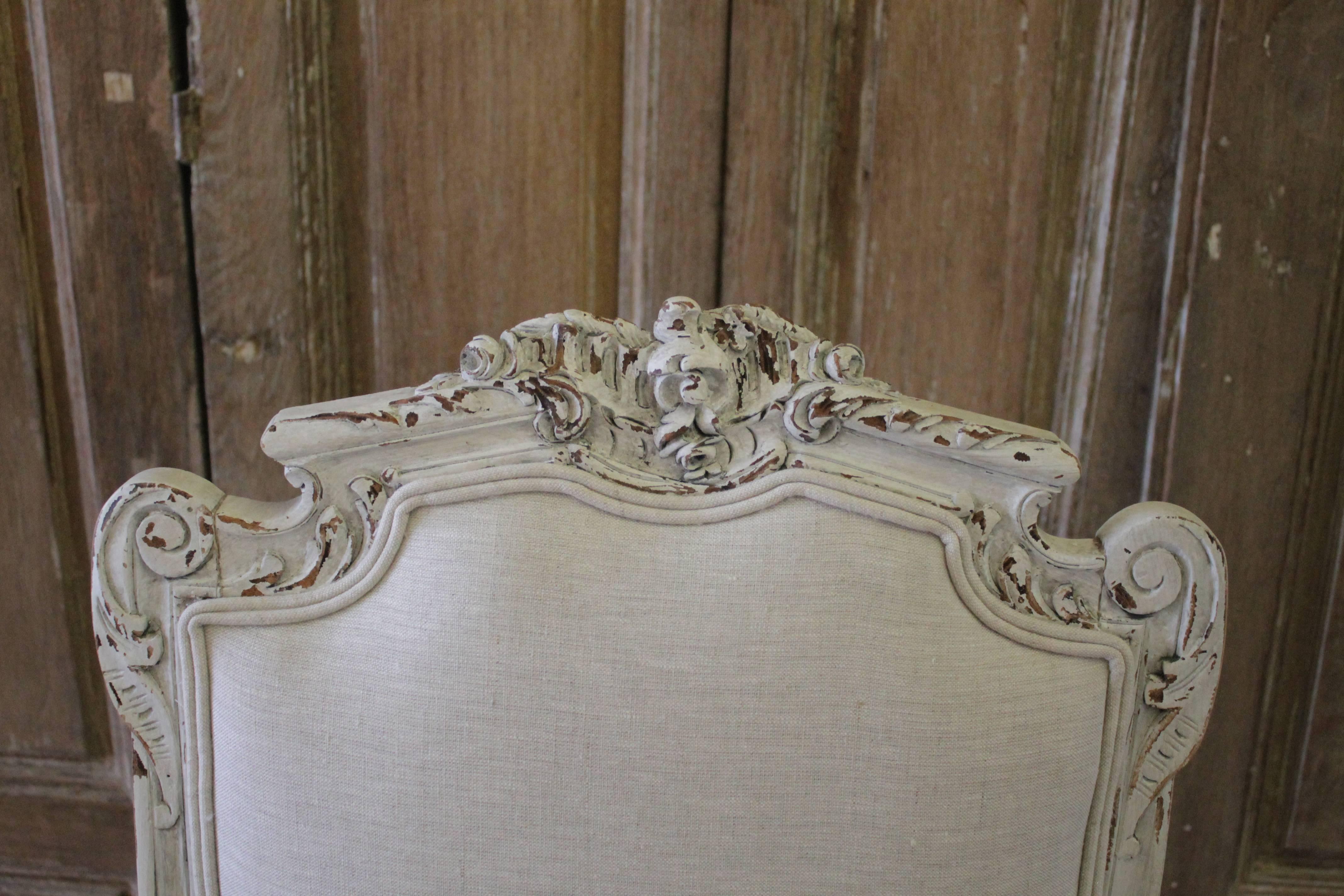 19th century antique carved and painted Rococo style vanity chairs in linen.
Painted in our oyster white, with subtle distressed edges, and finished with an antique patina. The paint color is not white, but rather a 