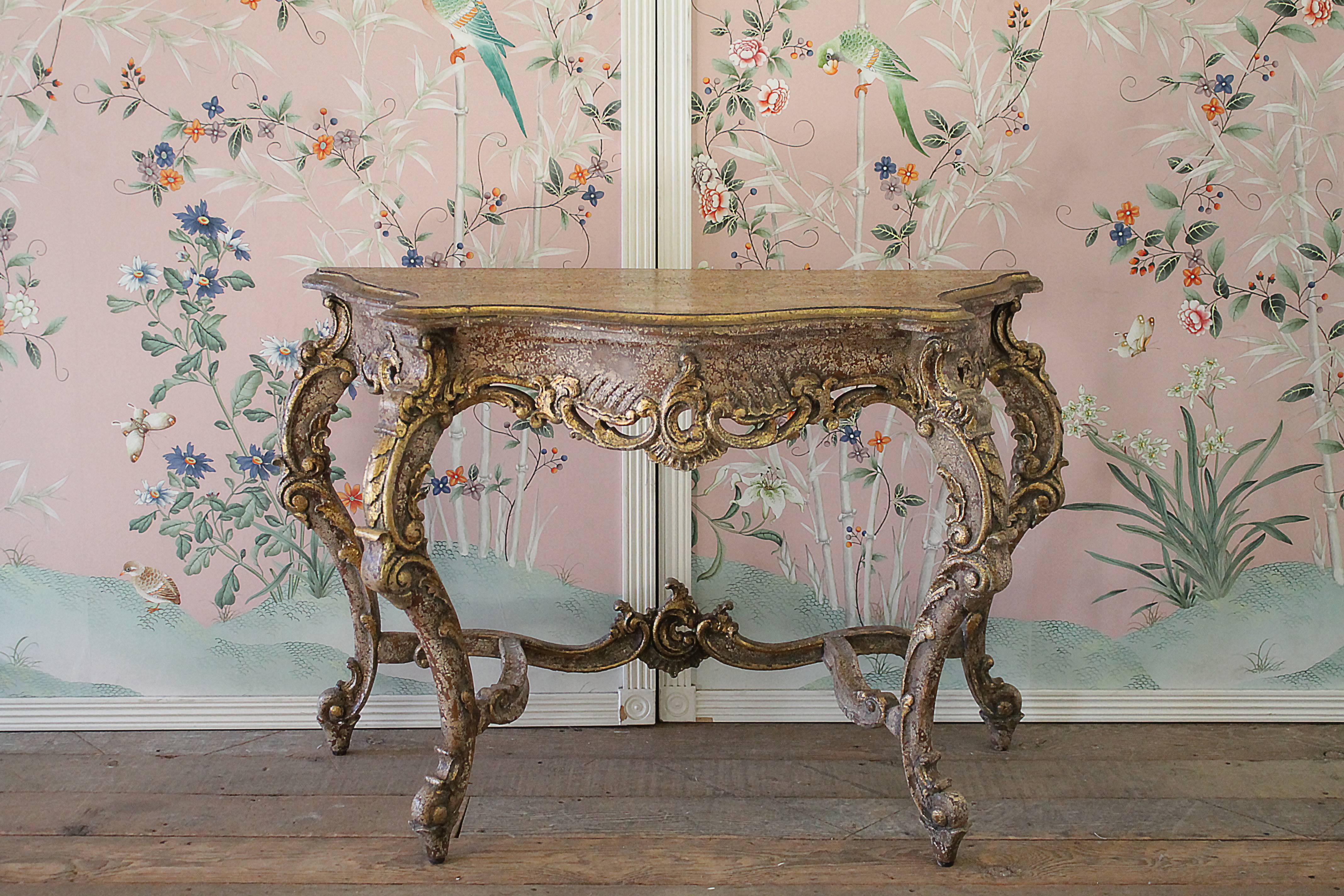 20th Century Gilt Console table with natural painted finish, subtle crackle effect, and gilt accents. Free standing on 4 legs, with large beautiful French Carvings.  Solid and sturdy ready for daily use.  
Measures 46